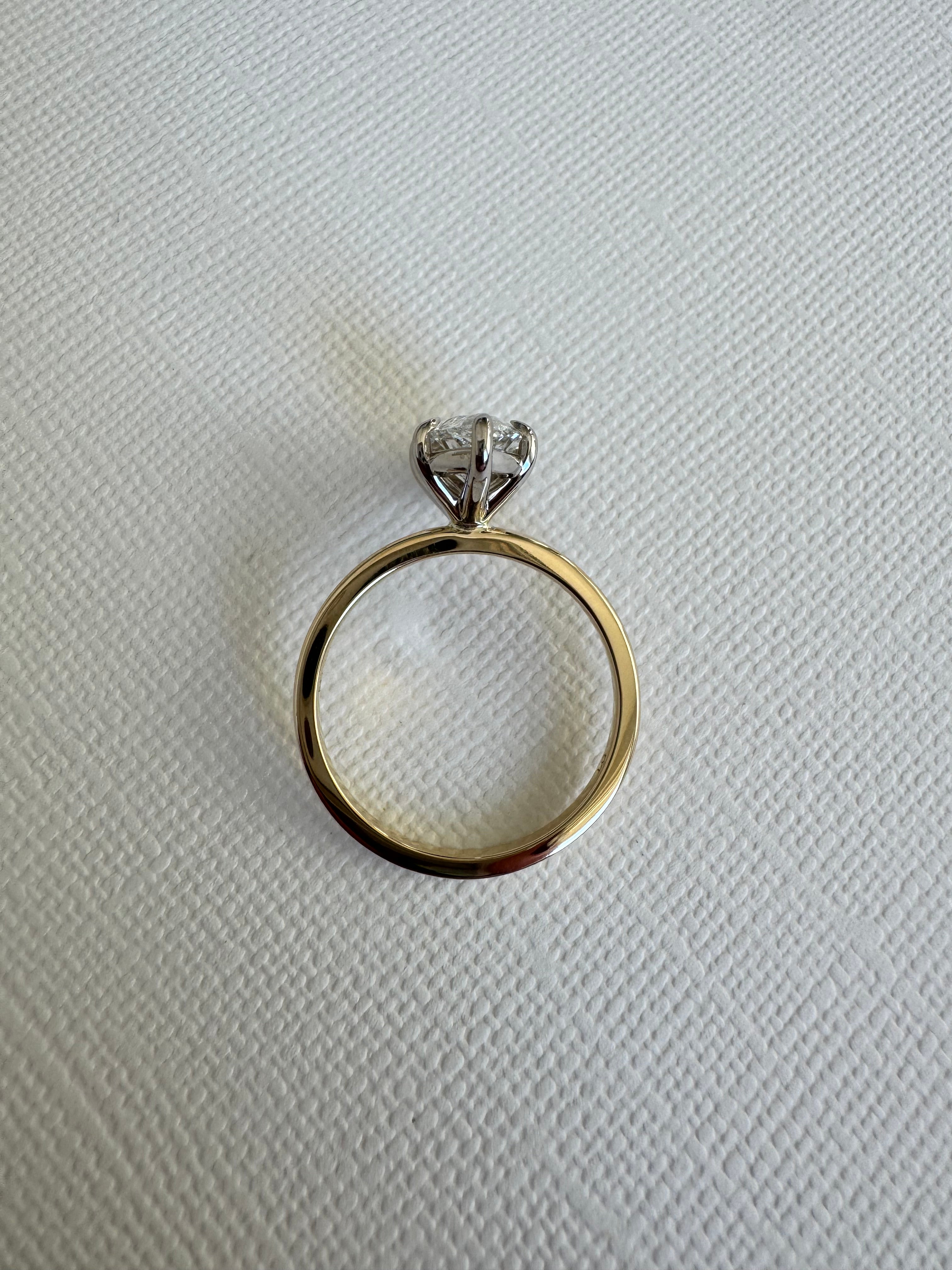 Custom 14k white and yellow gold lab grown marquise solitaire engagement ring. Size 8.5. Center= 2.10 ct lab grown marquise diamond (D color, VS1 clarity) IGI certified.