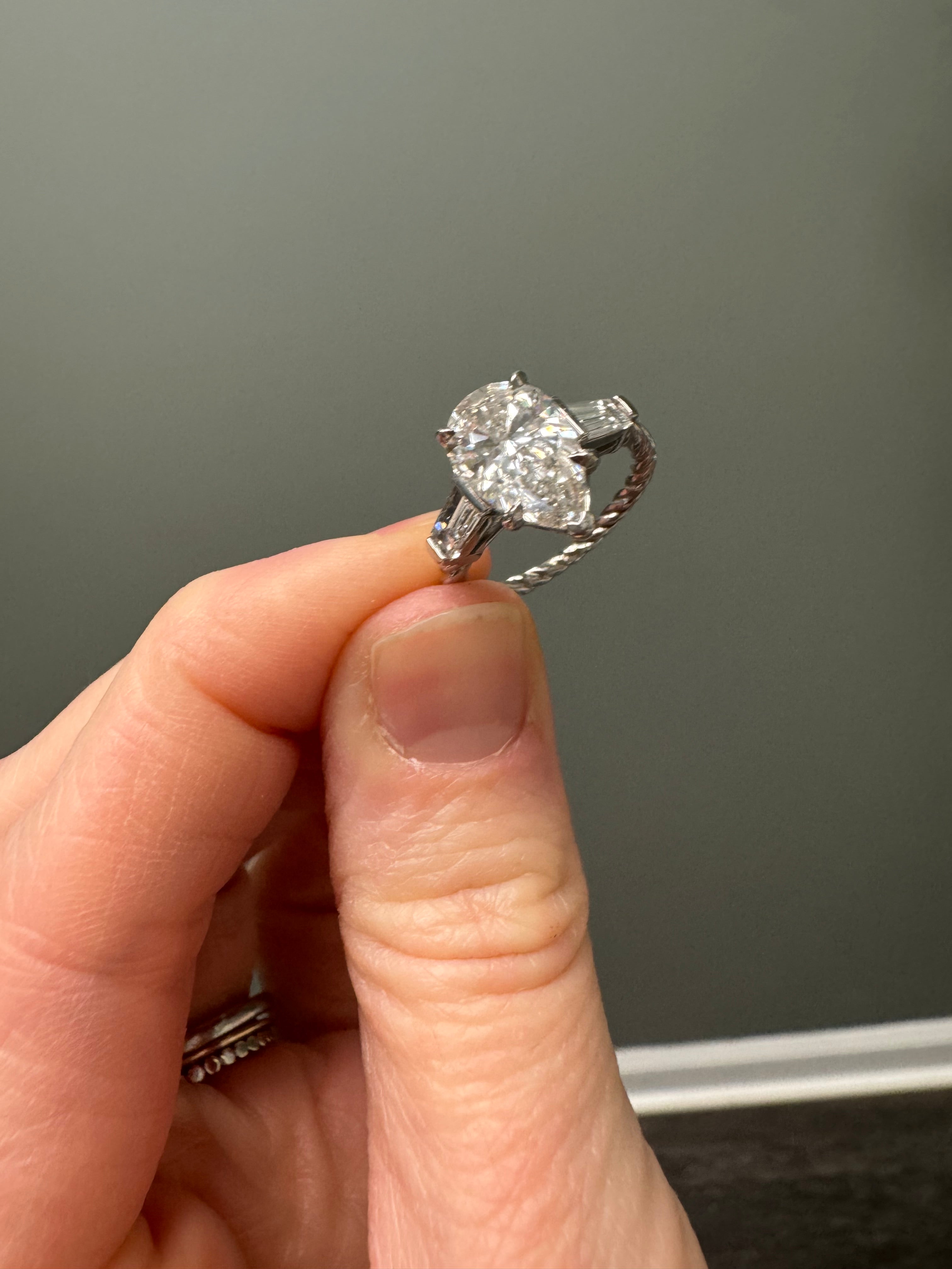 Size down to 5.5- Ladies white gold eng. ring with pear center and baguette accents and rope detail shank