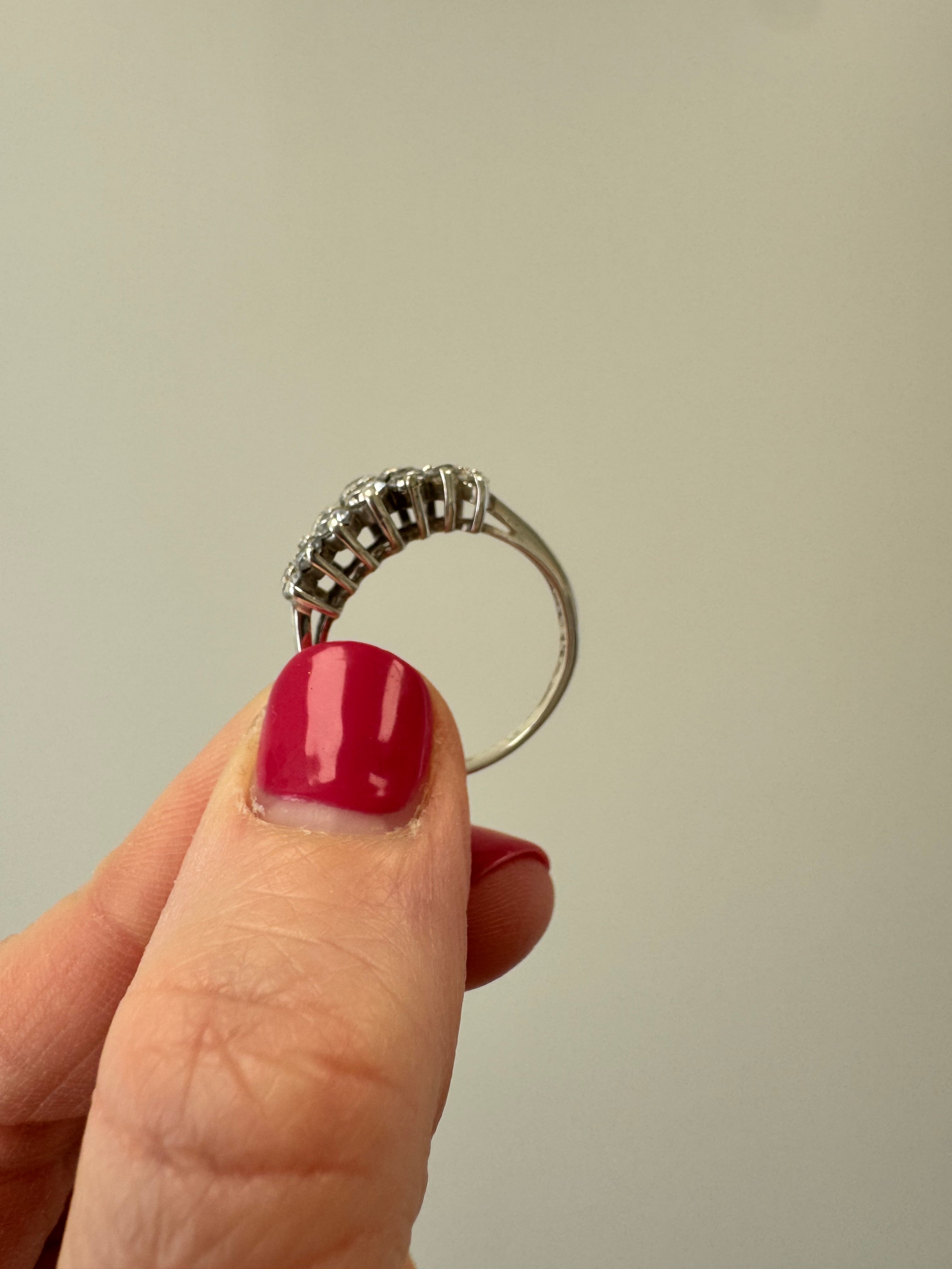 Replace missing CZ (use CZ from other ring provided by client). Retip this CZ & 1 other (3 over from missing one). Round out & polish.