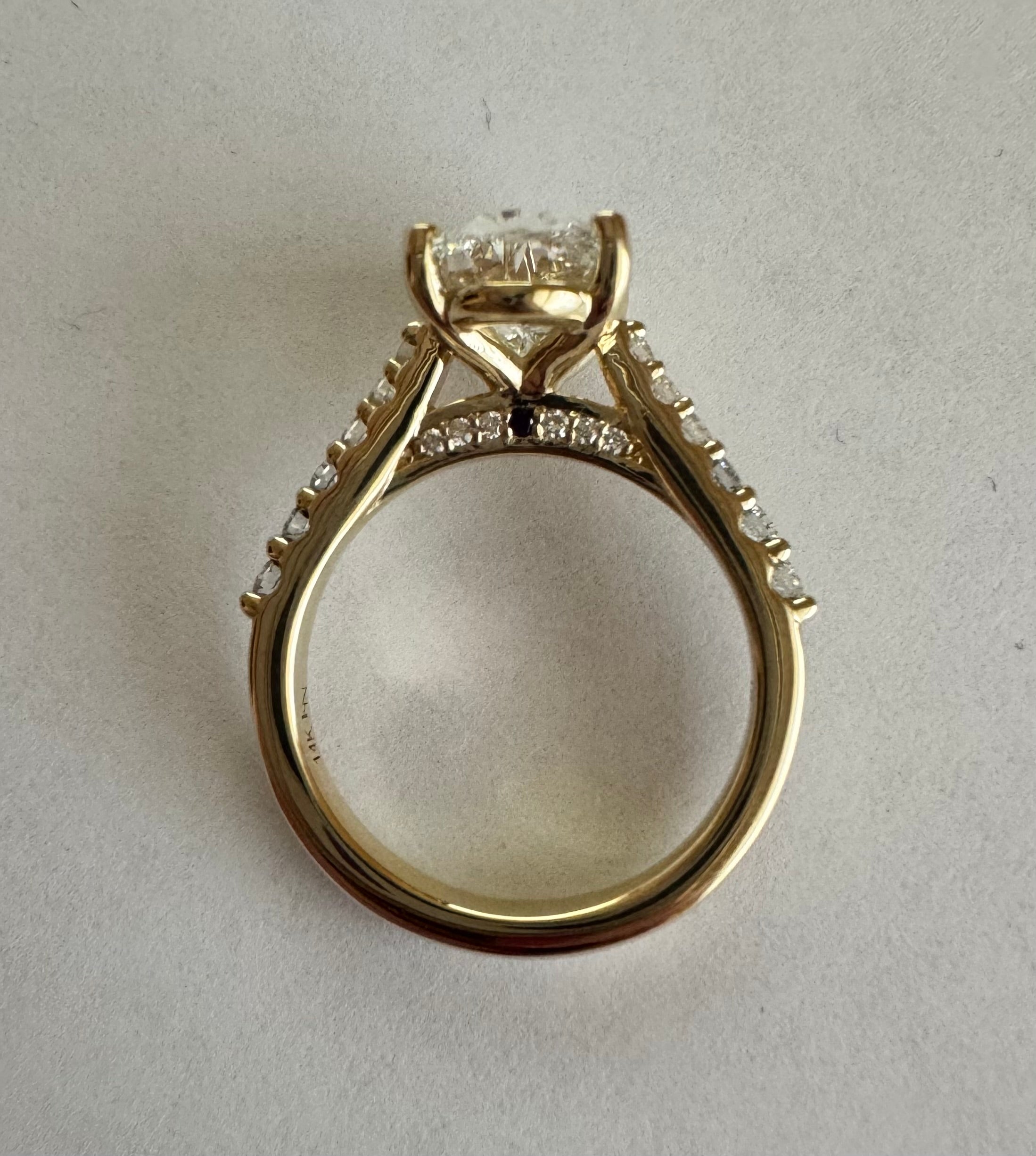Custom 14k yellow gold lab grown diamond engagement ring. Center diamond= 2.52 ct lab grown oval (D, VS2). Size 6.
