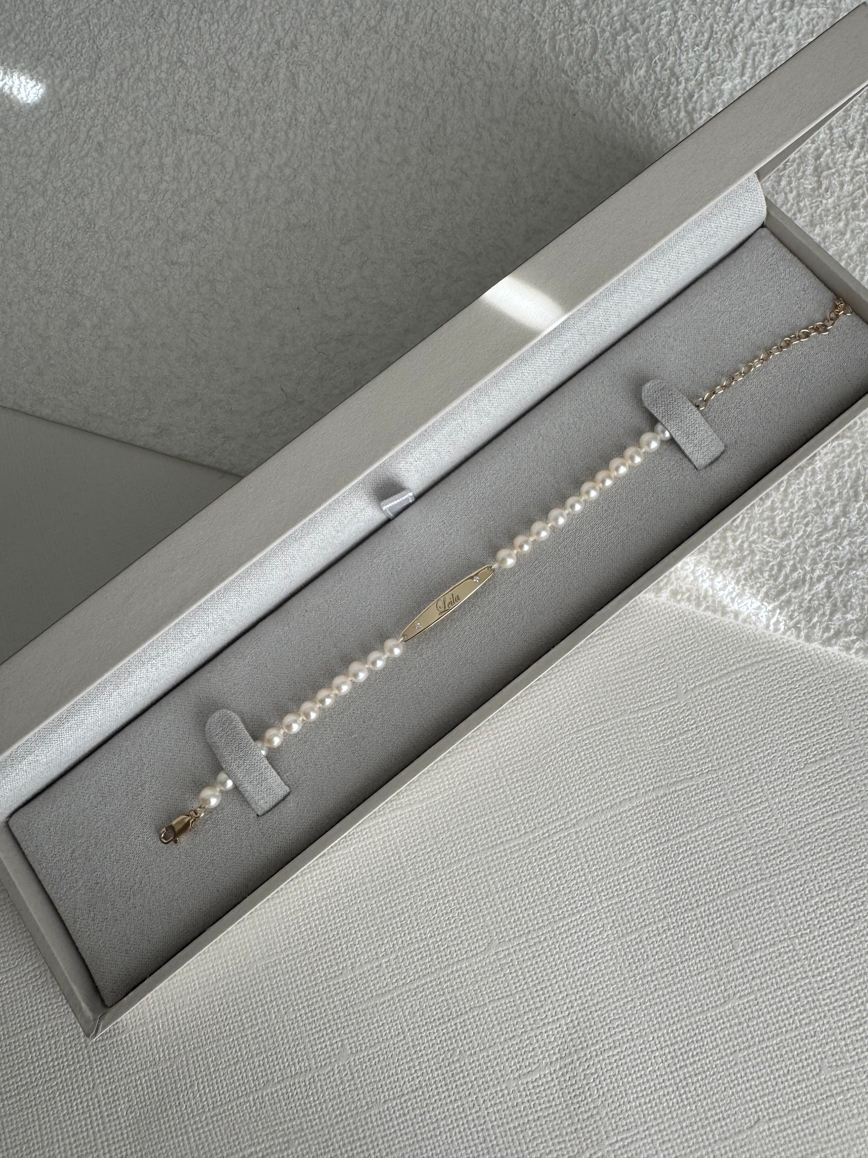 14k yellow gold engraved bar pearl bracelet with 2 moissanite engraved with "Leila". 5" with a 2" extender.