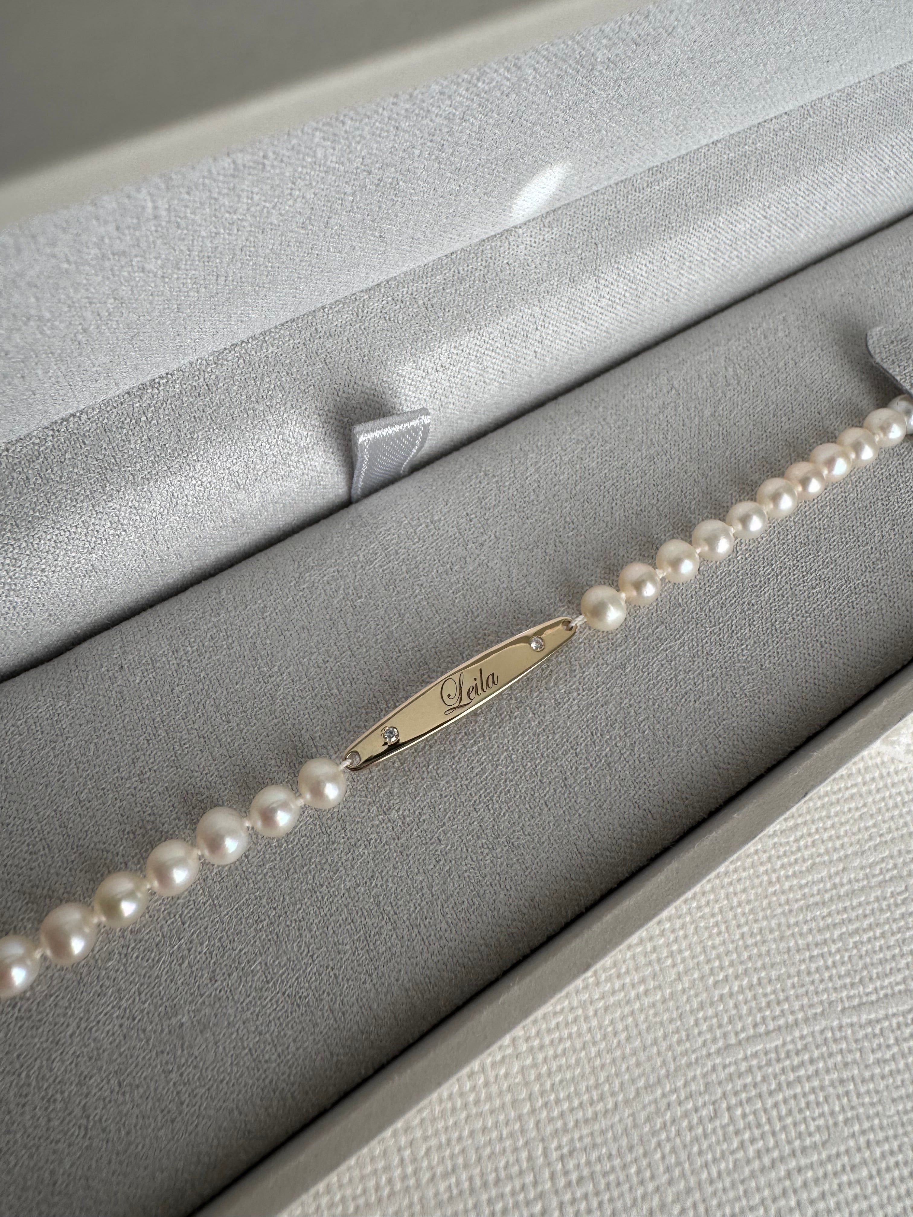 14k yellow gold engraved bar pearl bracelet with 2 moissanite engraved with "Leila". 5" with a 2" extender.