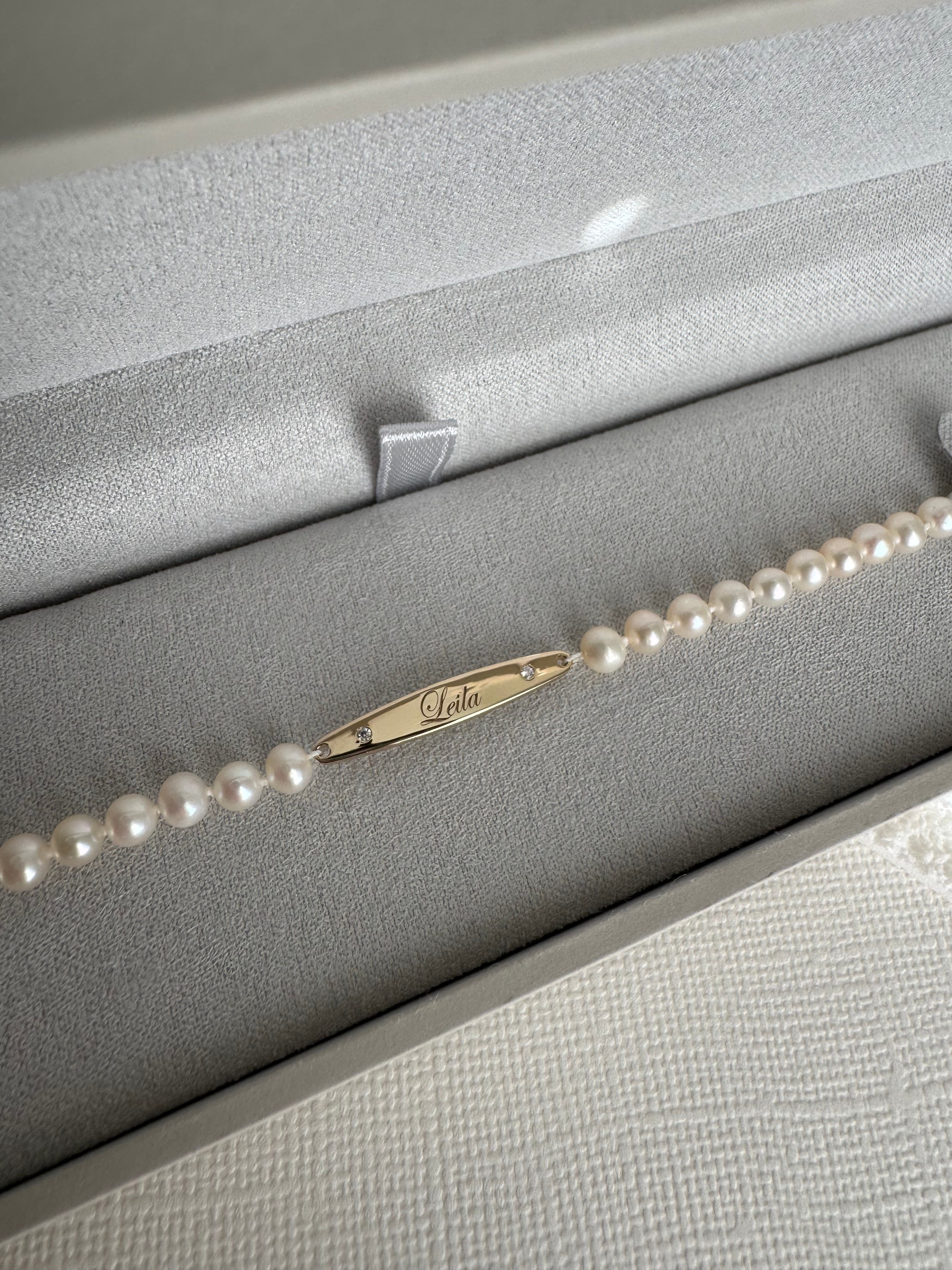 14k yellow gold engraved bar pearl bracelet with 2 moissanite engraved with "Leila". 5" with a 2" extender.