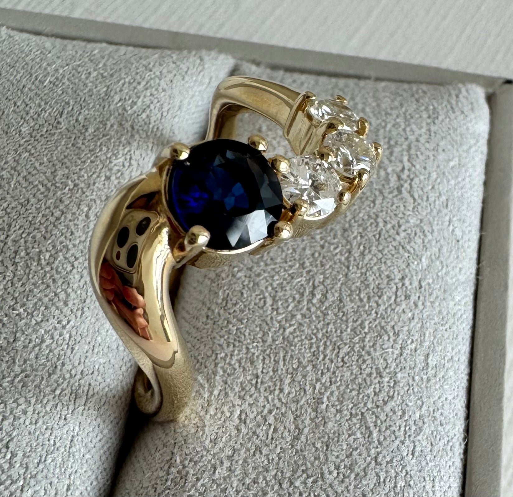 Custom 10k yellow gold wave style ring with 1 round sapphire & 3 round diamonds (sapphire= 1.04 cts, dias= 0.19 cts, 0.15 cts, 0.21 cts) Size 10.