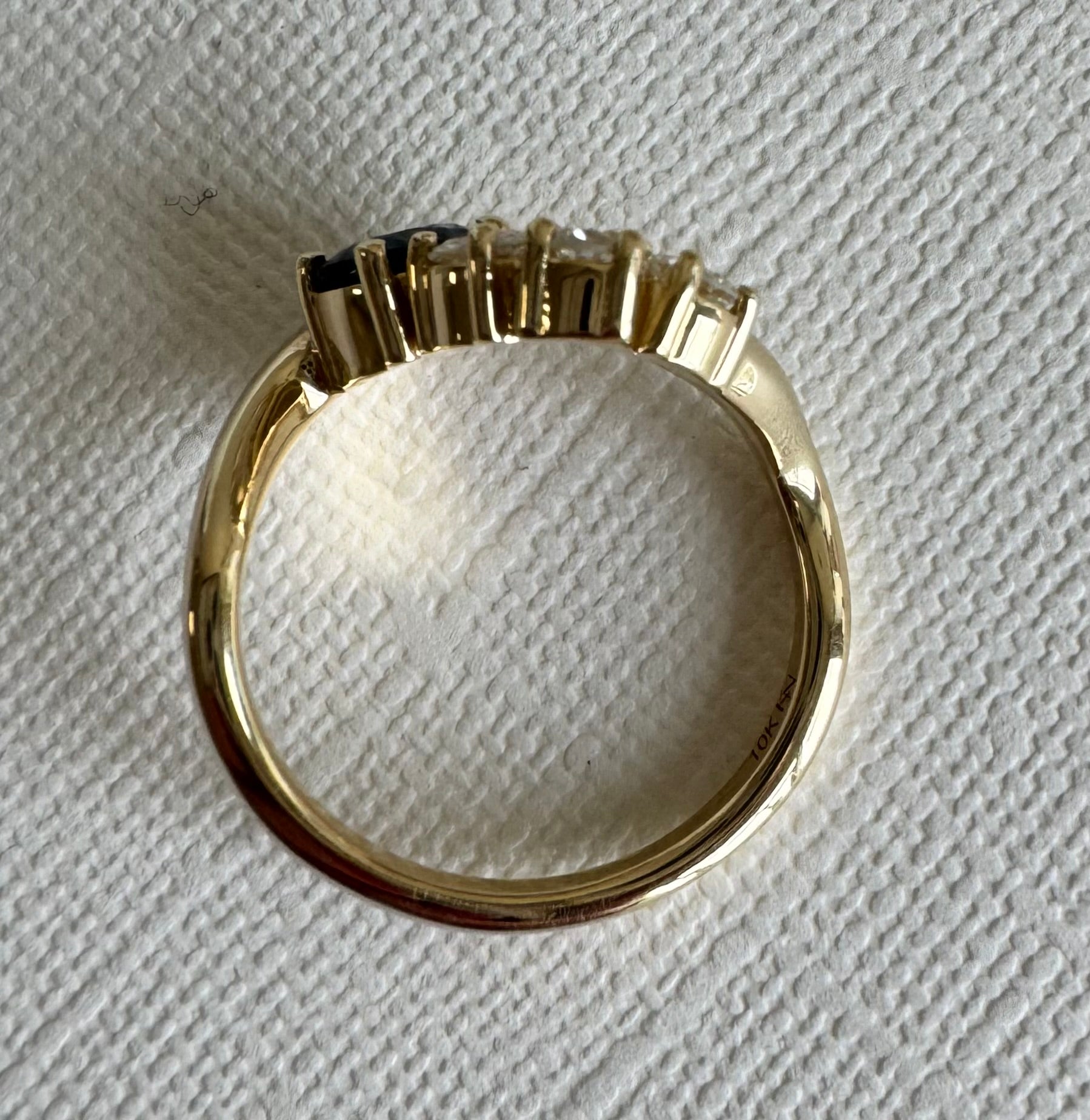 Custom 10k yellow gold wave style ring with 1 round sapphire & 3 round diamonds (sapphire= 1.04 cts, dias= 0.19 cts, 0.15 cts, 0.21 cts) Size 10.