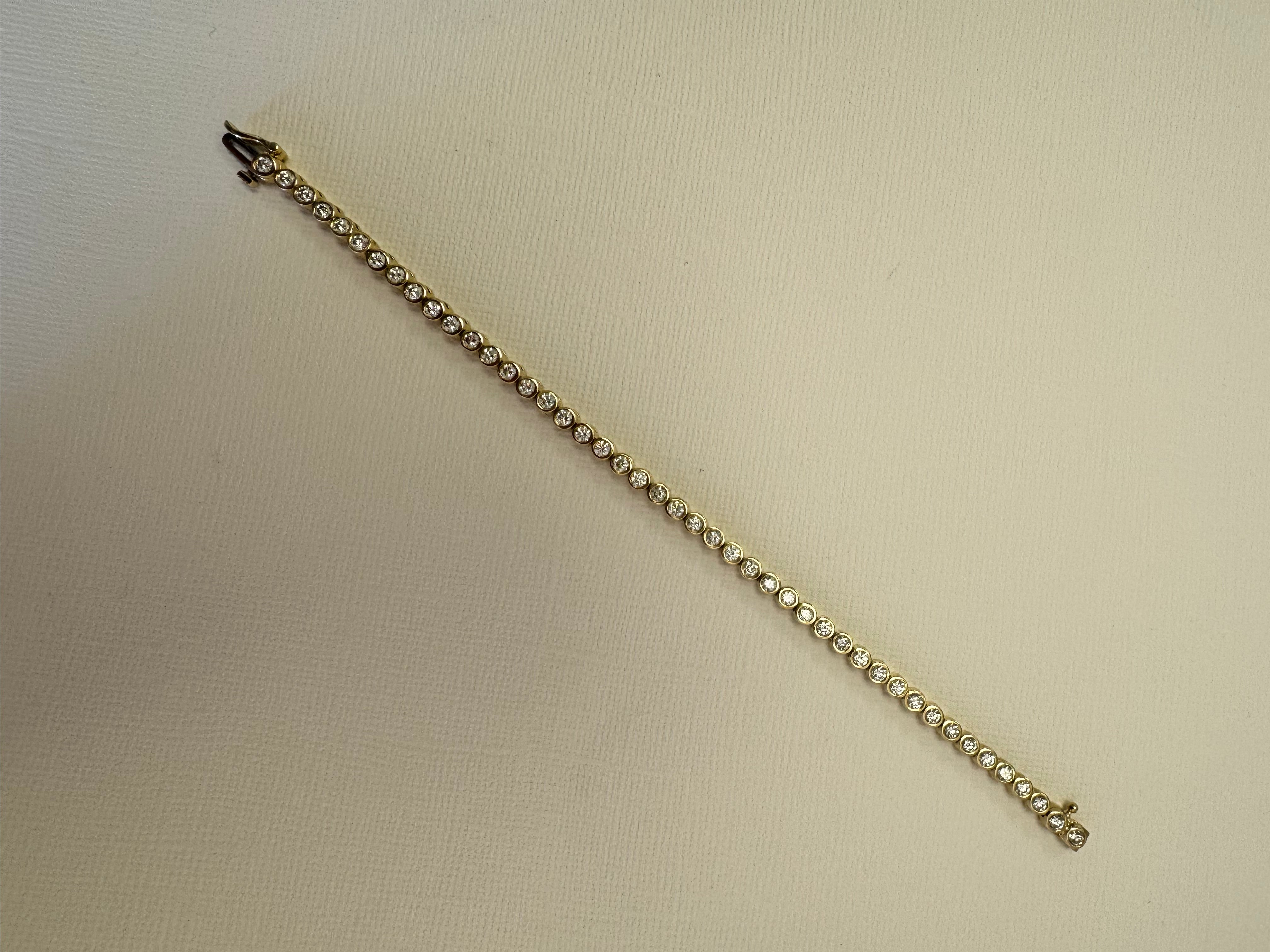 10k yellow gold bezel set diamond tennis bracelet using client's 43, 2.5mm diamonds. Approx 2.58 cttw. (Client has 12 leftover diamonds & we removed 4 links from the bracelet)