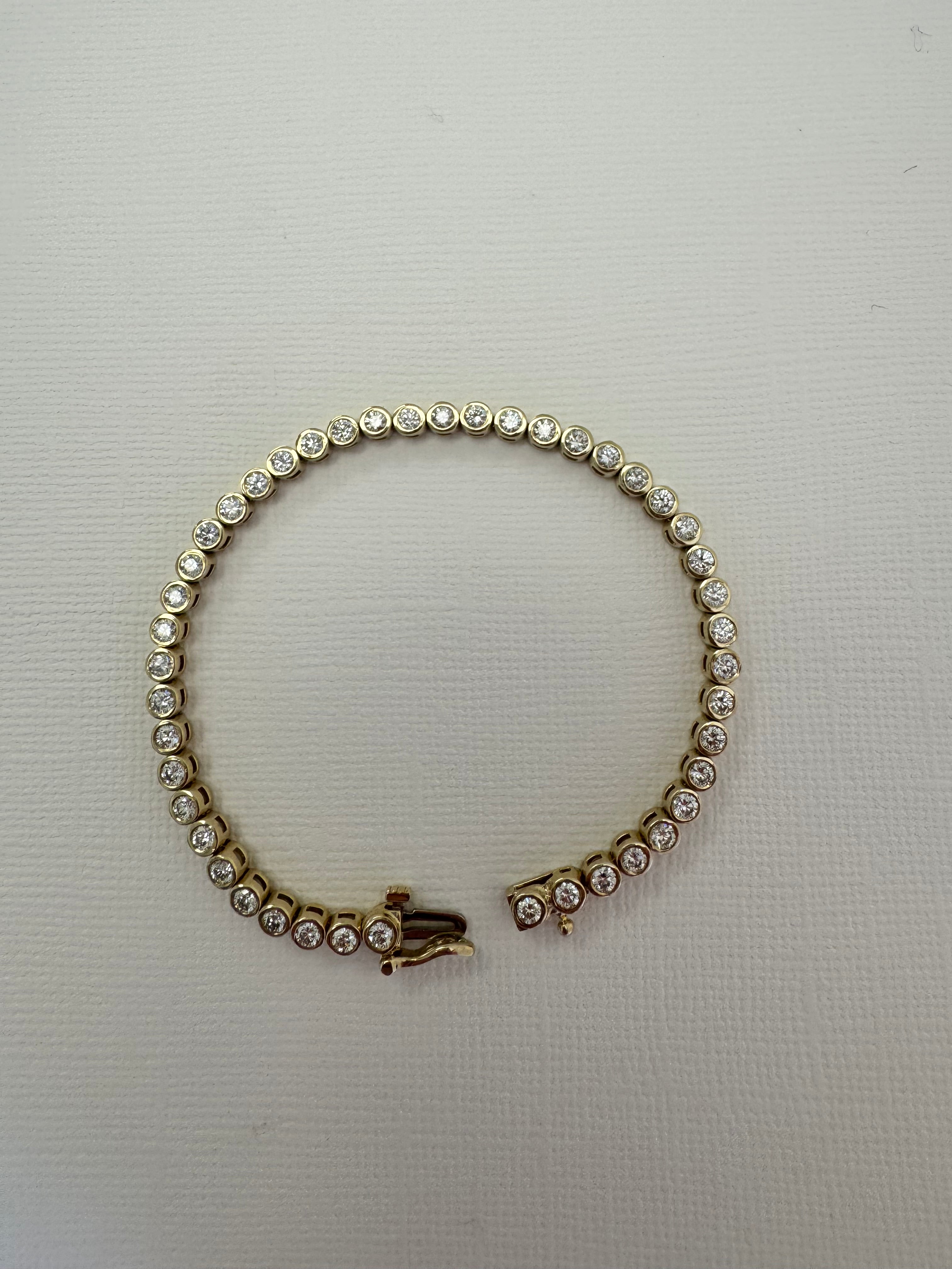 10k yellow gold bezel set diamond tennis bracelet using client's 43, 2.5mm diamonds. Approx 2.58 cttw. (Client has 12 leftover diamonds & we removed 4 links from the bracelet)