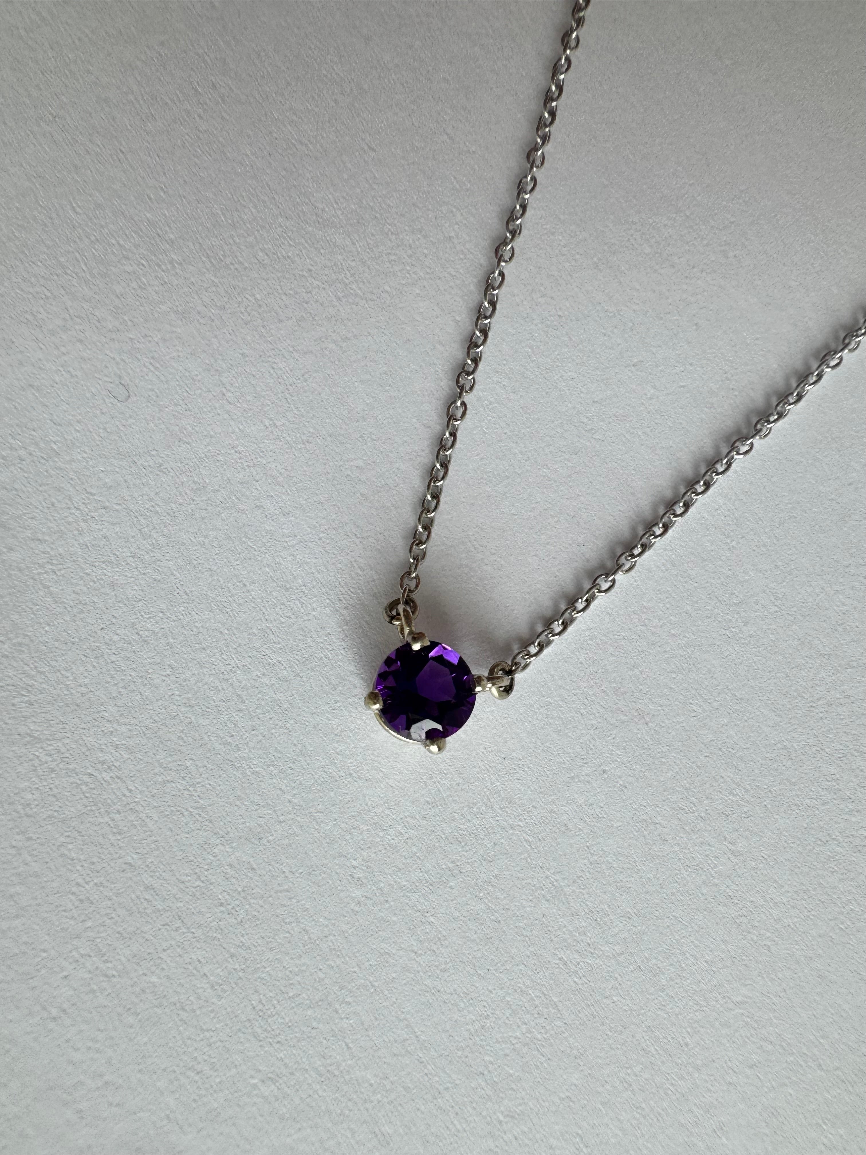 14k white gold solitaire amethyst necklace with 1, 5mm round AAA genuine faceted amethyst stationed in the chain in a 4 prong basket setting. 18" with a jump ring at 16".