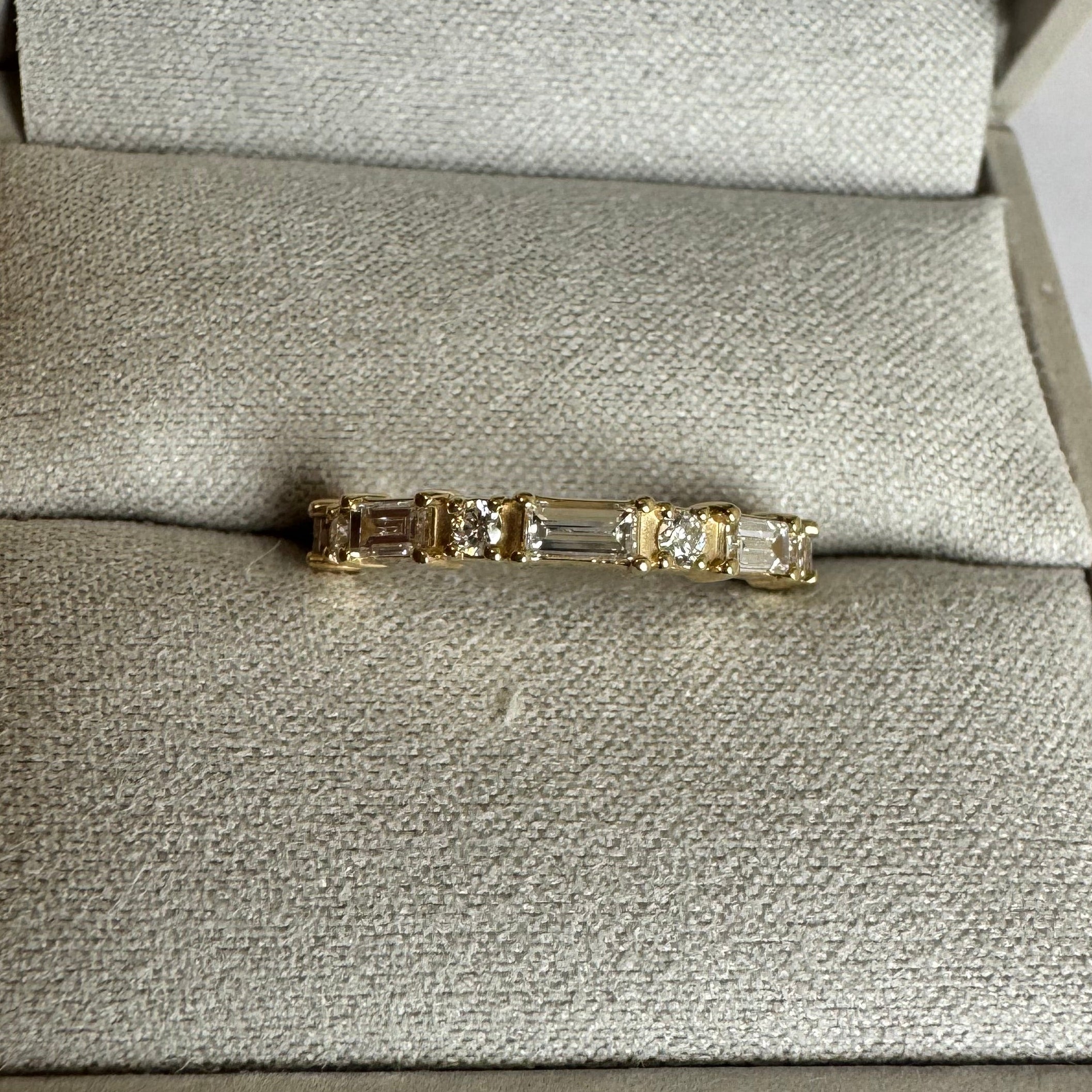 14k yellow lab grown alternating baguette and round diamond band in a size 6. 0.67 cttw.