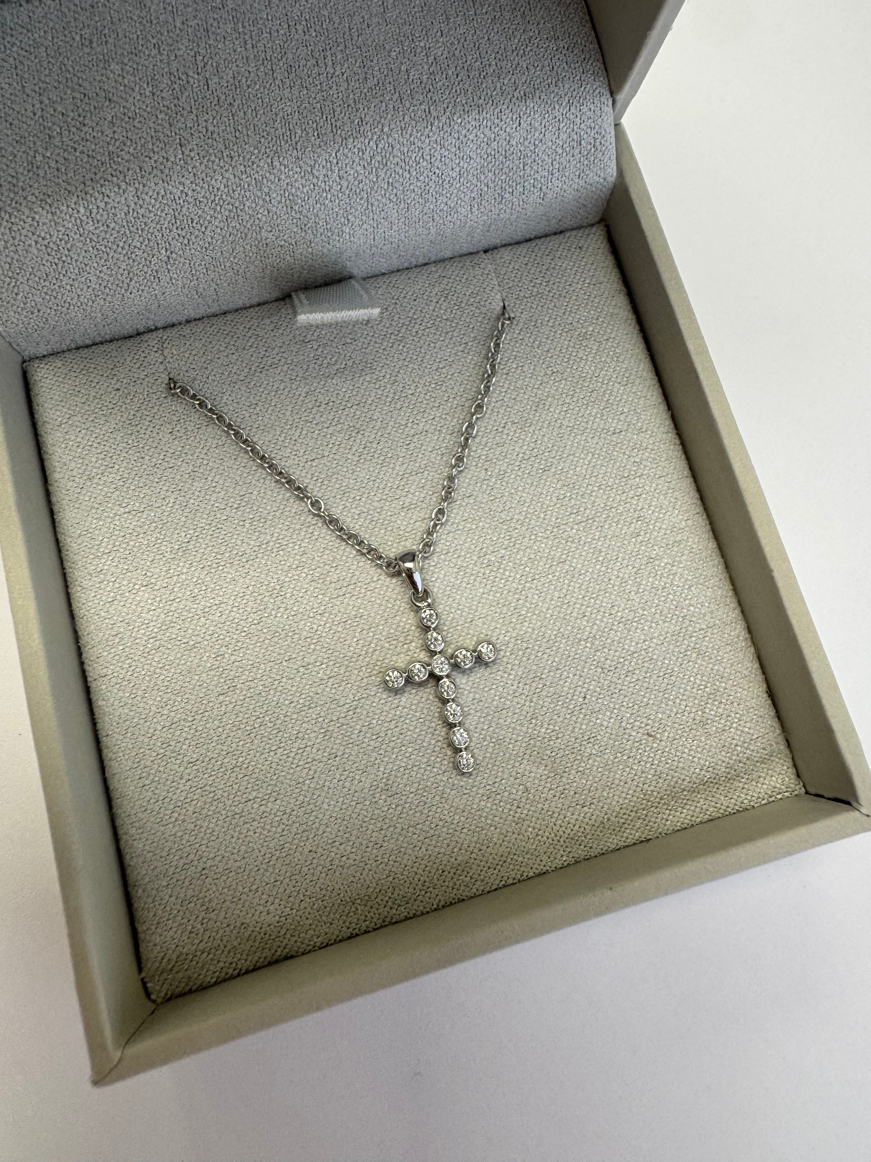 White gold diamond cross necklace (pendant= 1/10ct natural diamonds in 14k w/g) (chain= 10k w/g 1.5mm cable 16+2")