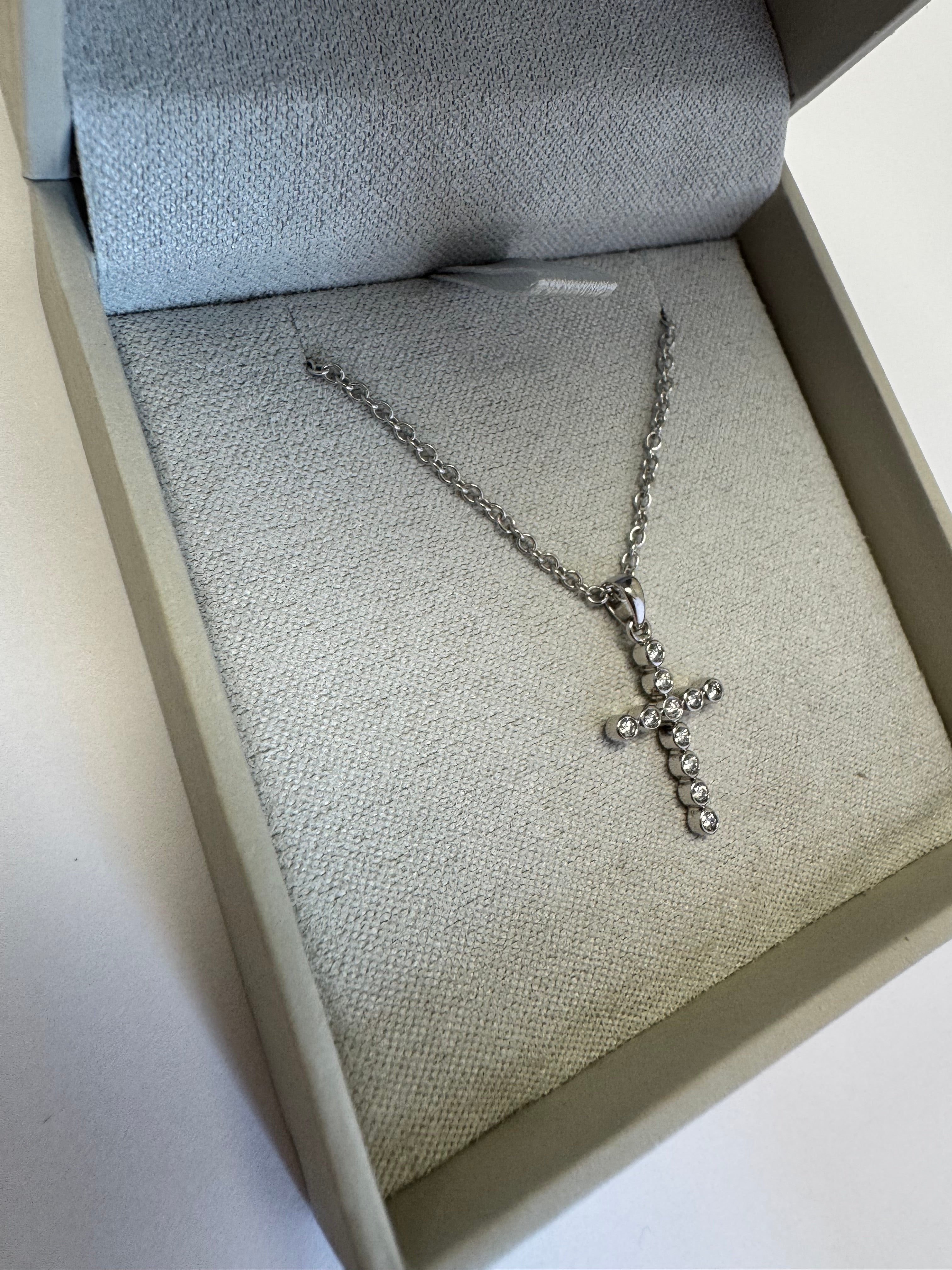 White gold diamond cross necklace (pendant= 1/10ct natural diamonds in 14k w/g) (chain= 10k w/g 1.5mm cable 16+2")