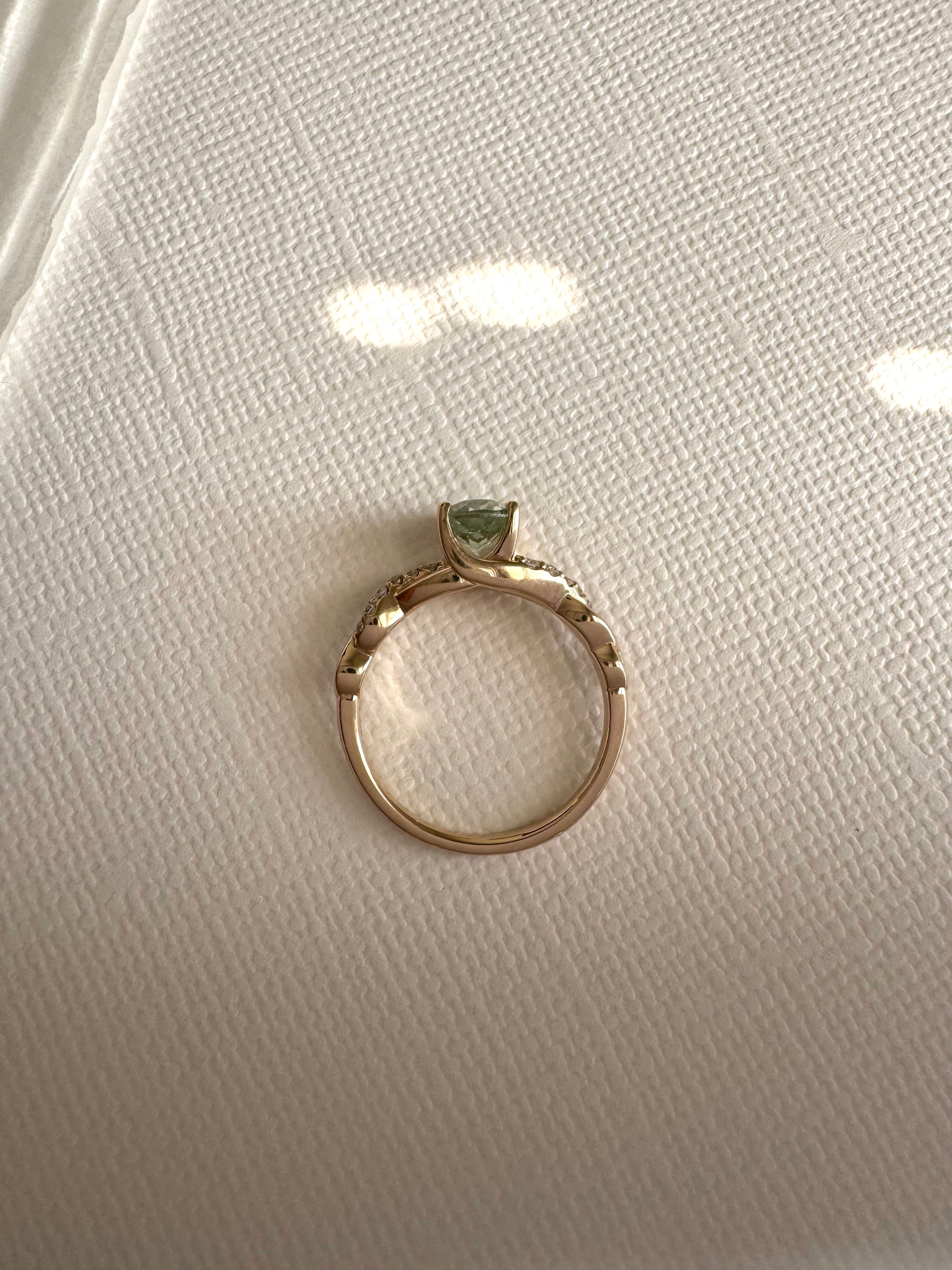 Custom 14k yellow gold lab grown oval green sapphire (1.12 cts.) and lab grown diamond (approx. 0.095cts.) engagement ring. Size 5.5