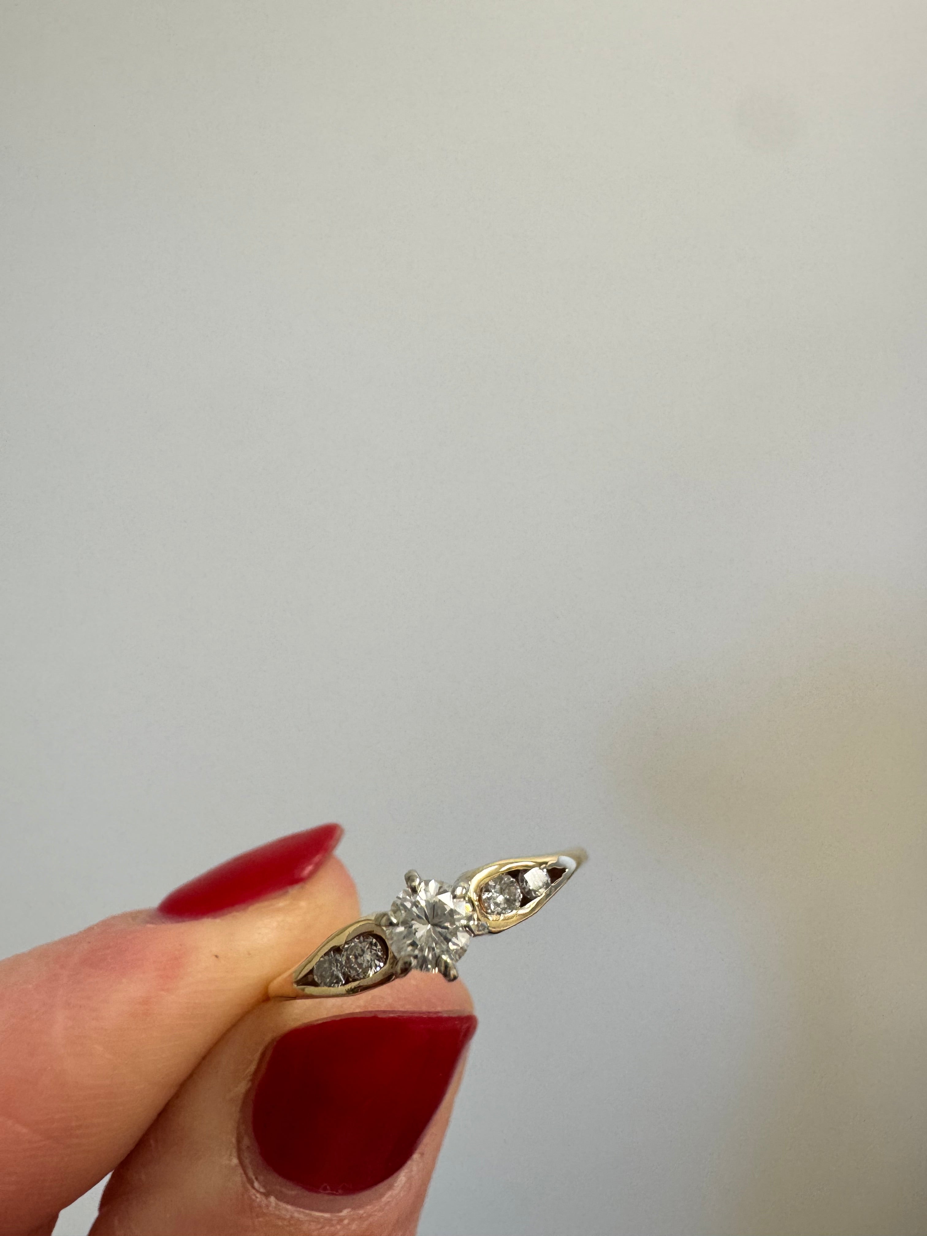 Ladies yellow gold engagement ring with 1 center and 4 melee diamonds. Size up to 5.5 from 5.