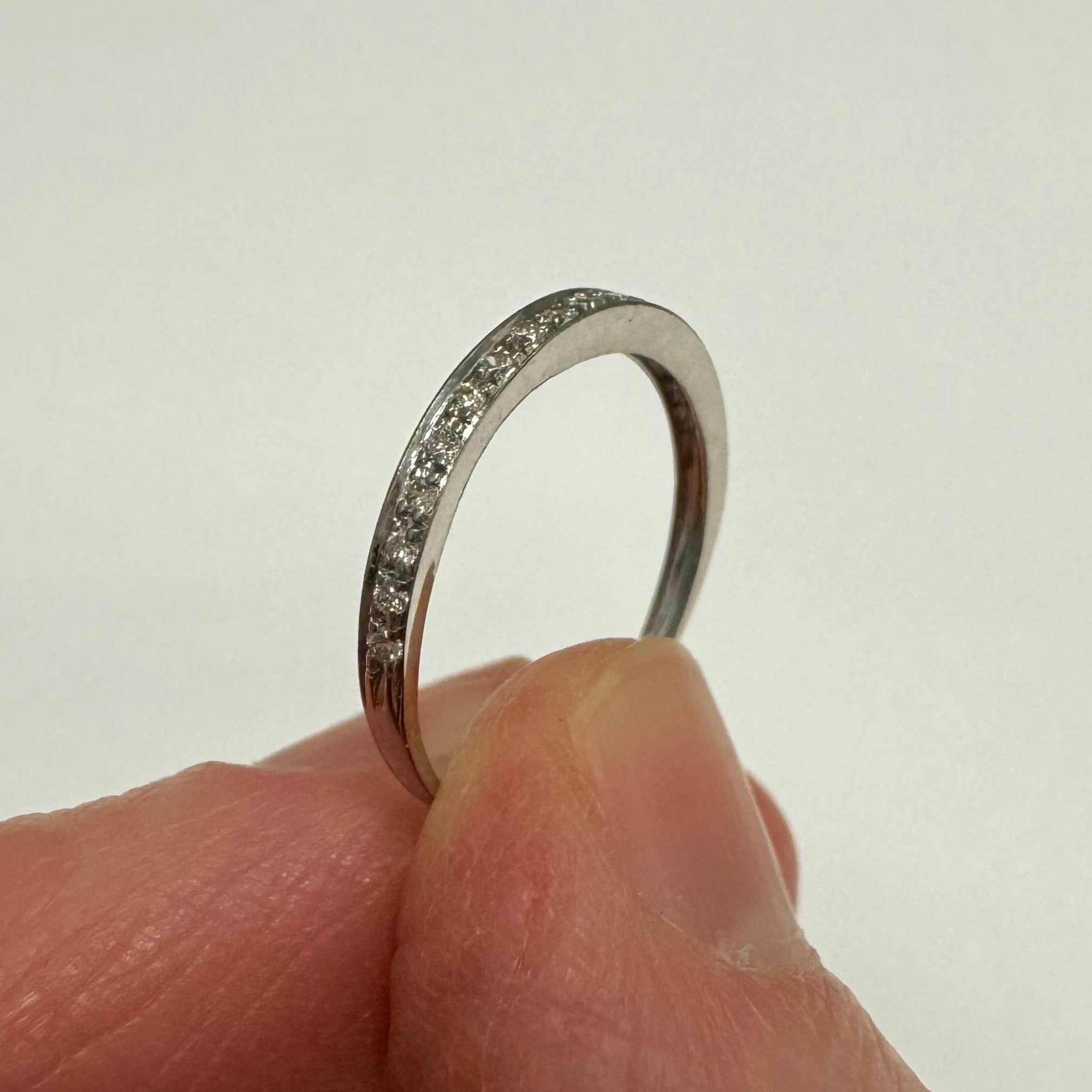 Repair: 10k white gold bead set diamond band. clean, polish, rhodium & smooth out inner edge.