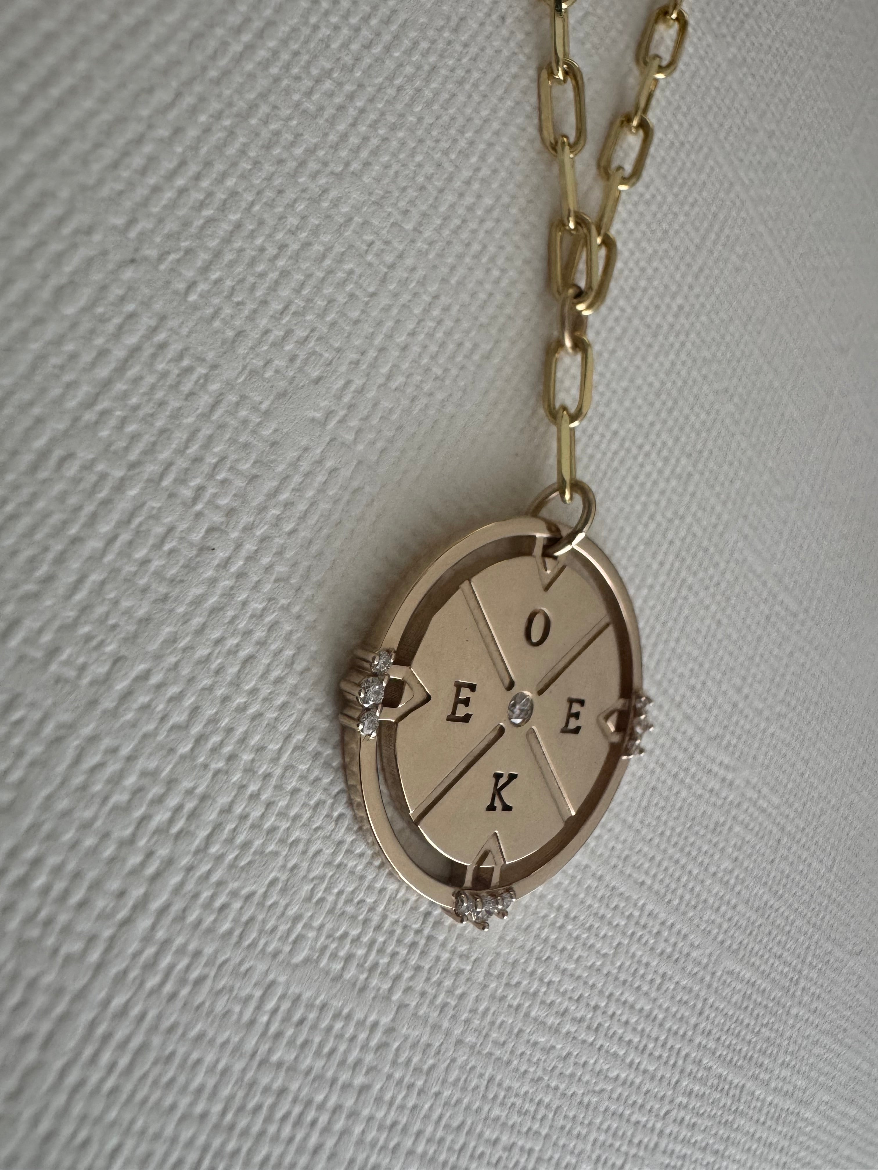 14k yellow gold compass necklace on a 22" paper clip chain with initials O, E, E, K and 10 round natural diamonds