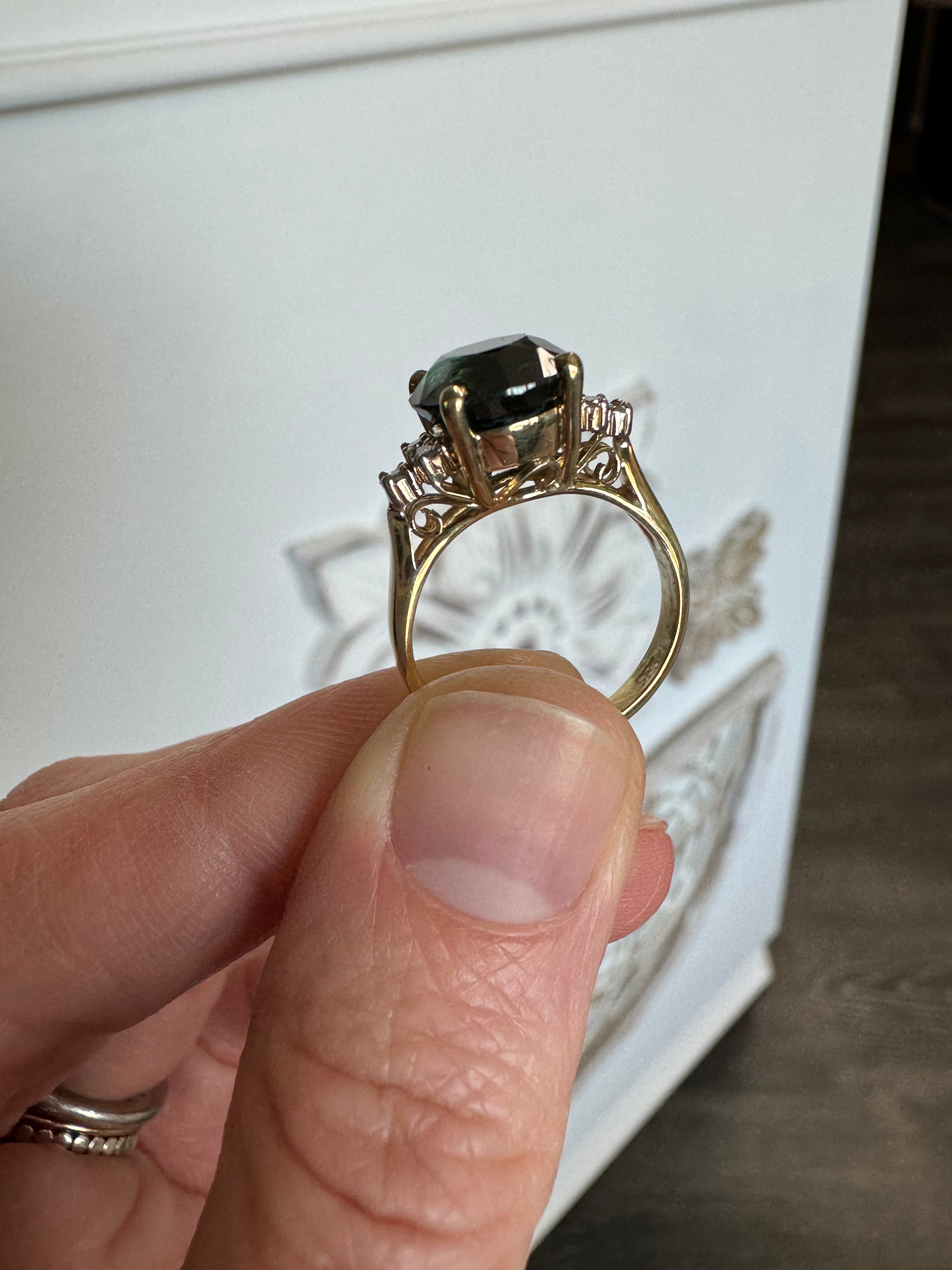 Size customer's 14k yellow gold diamond ring with a green center gemstone down to a 5