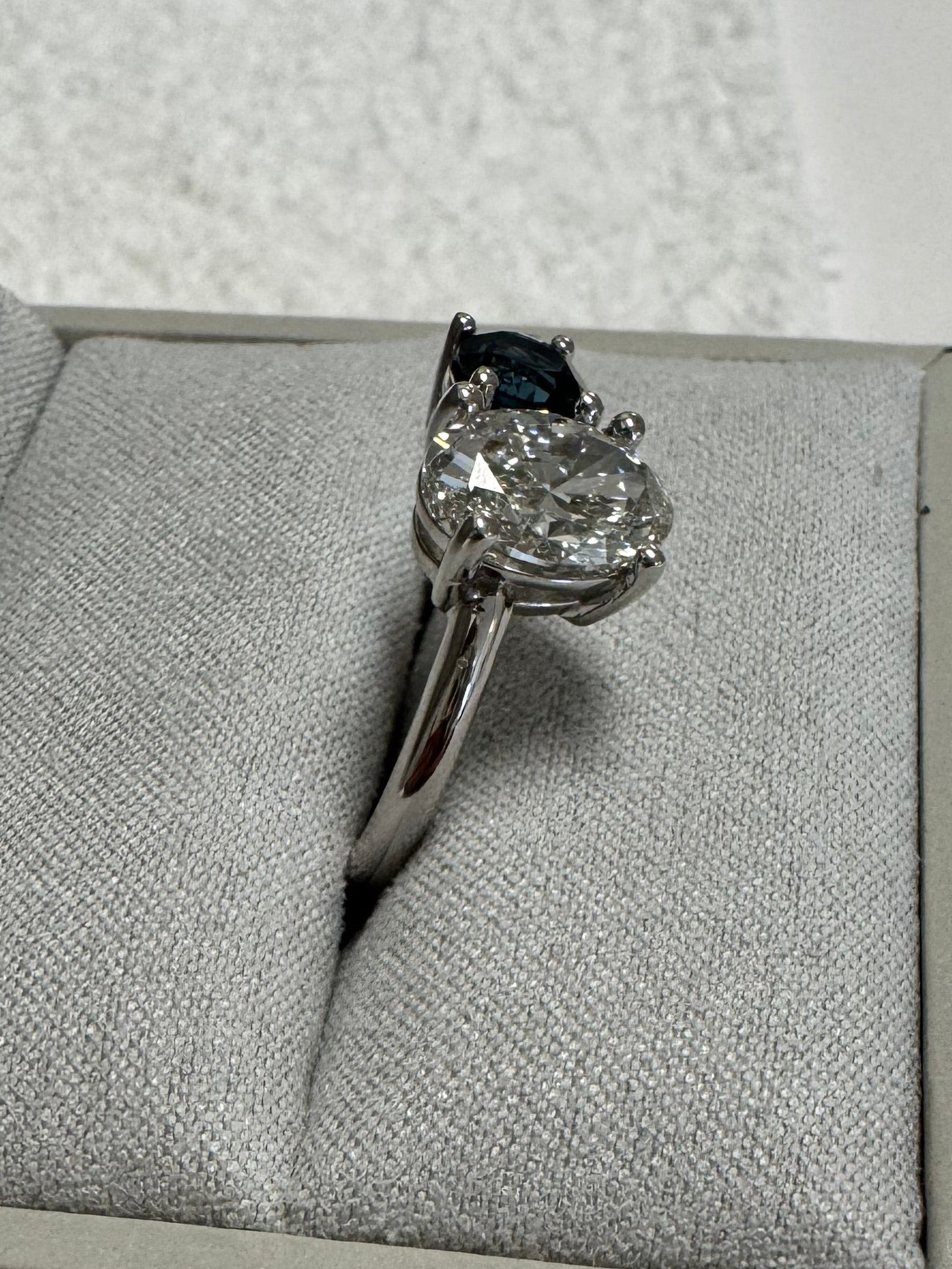 Custom 14k white gold 2 stone ring using customer's 2ct. oval lab grown diamond & supplying 1, 5.5mm round AA quality London Blue Topaz. Size 9.