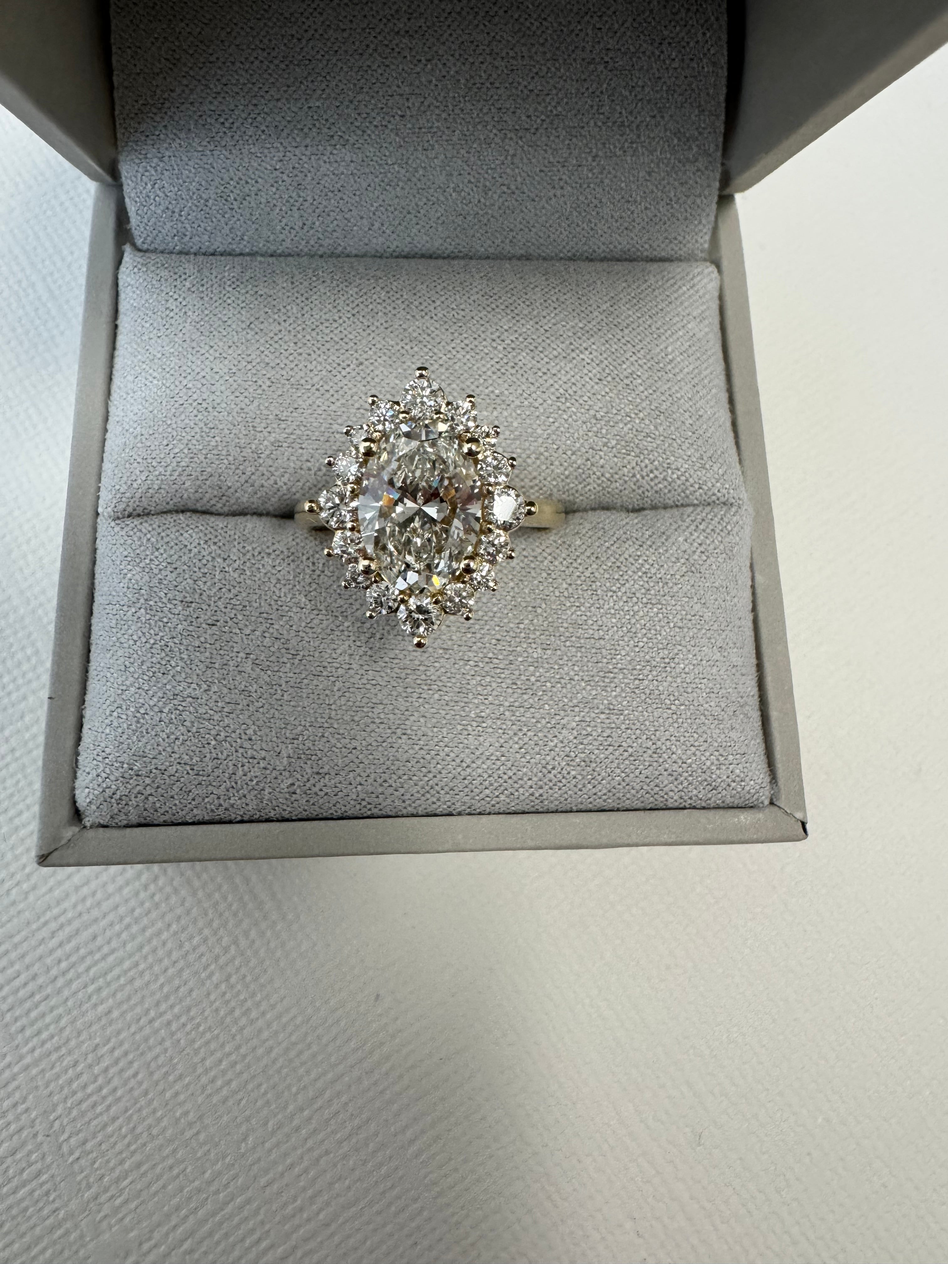 Custom 14k yellow gold lab grown oval diamond starburst halo ring using 6 of customer's natural round diamonds. Size 5.75.