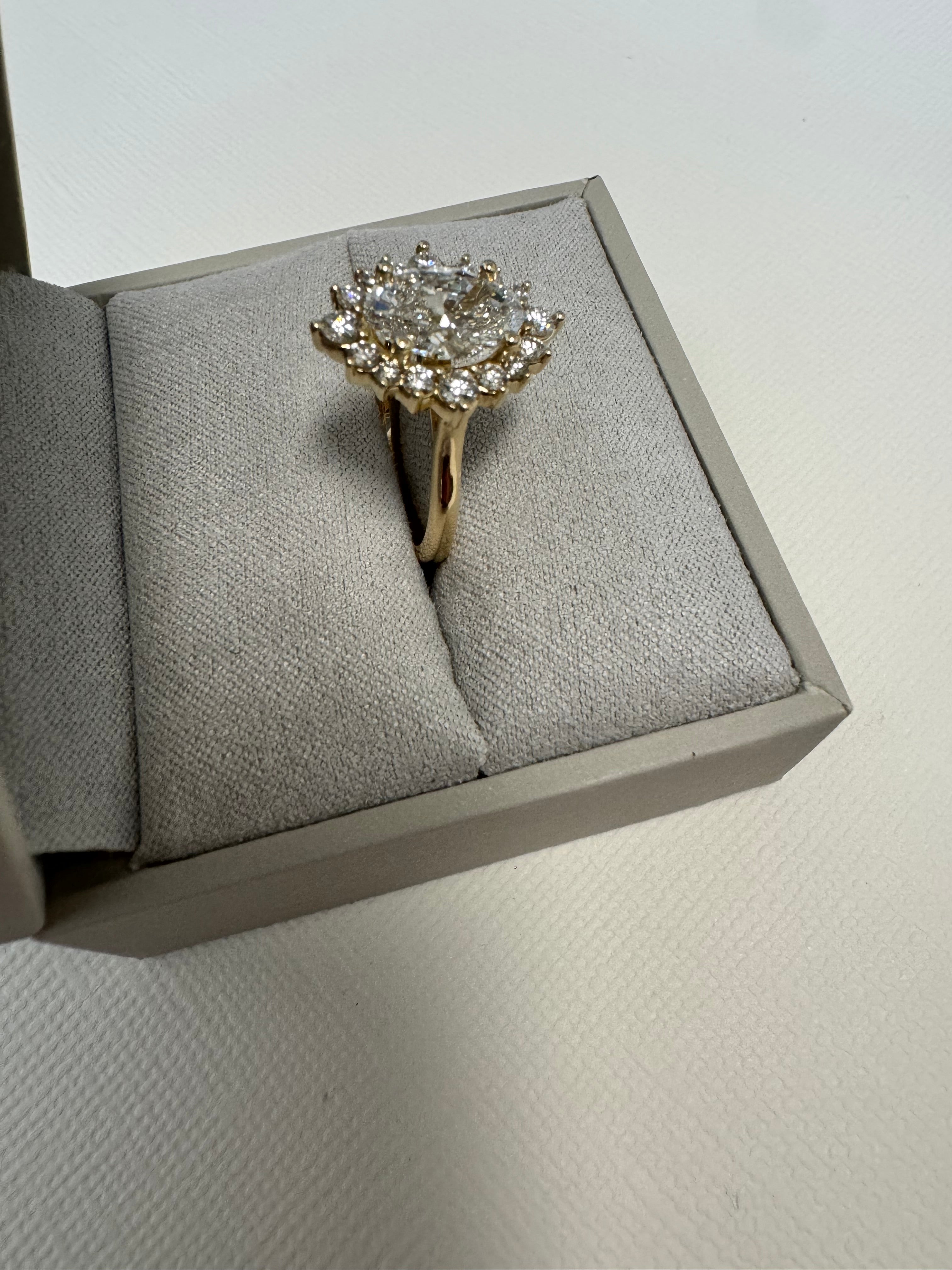 Custom 14k yellow gold lab grown oval diamond starburst halo ring using 6 of customer's natural round diamonds. Size 5.75.