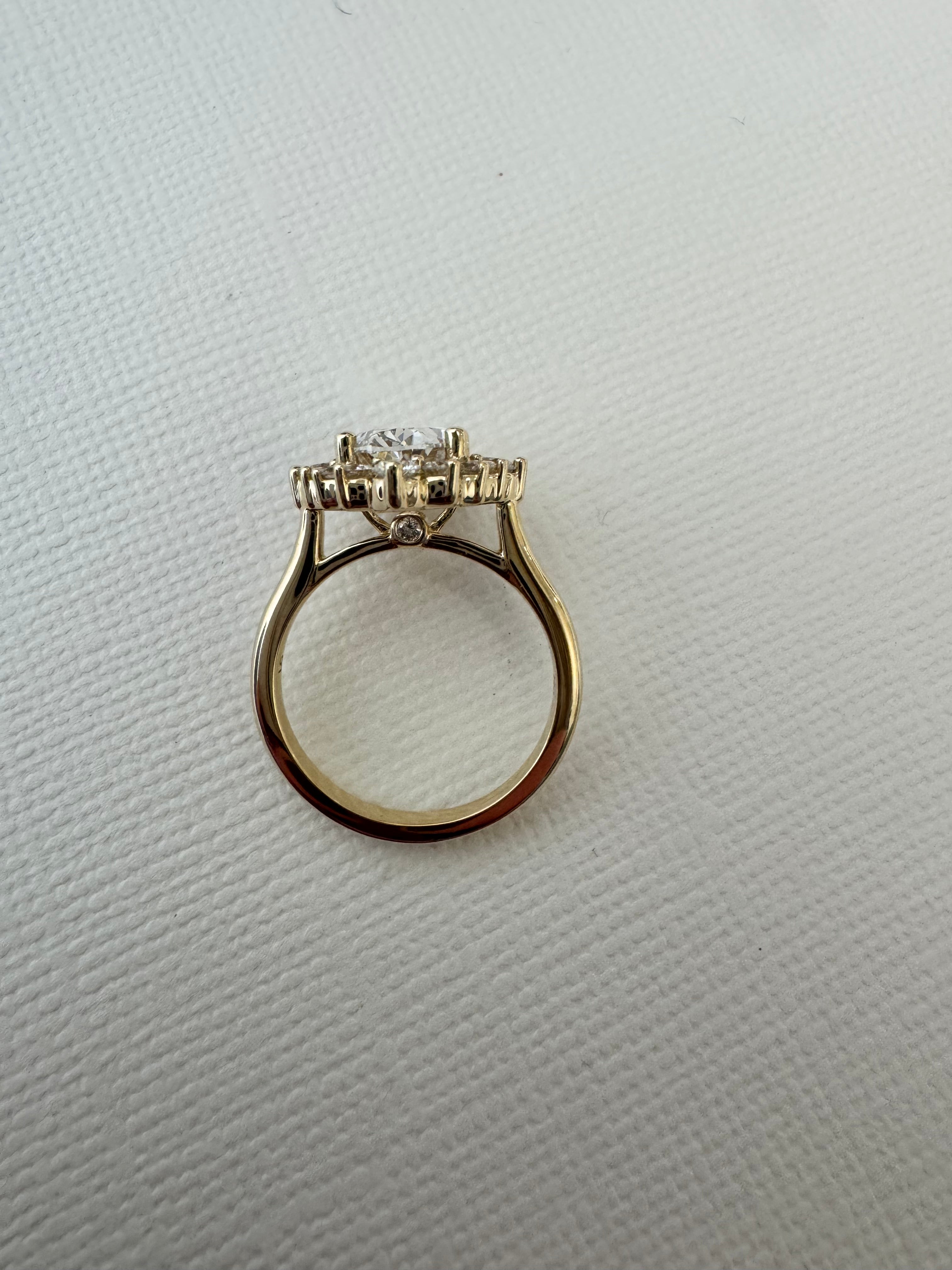 Custom 14k yellow gold lab grown oval diamond starburst halo ring using 6 of customer's natural round diamonds. Size 5.75.