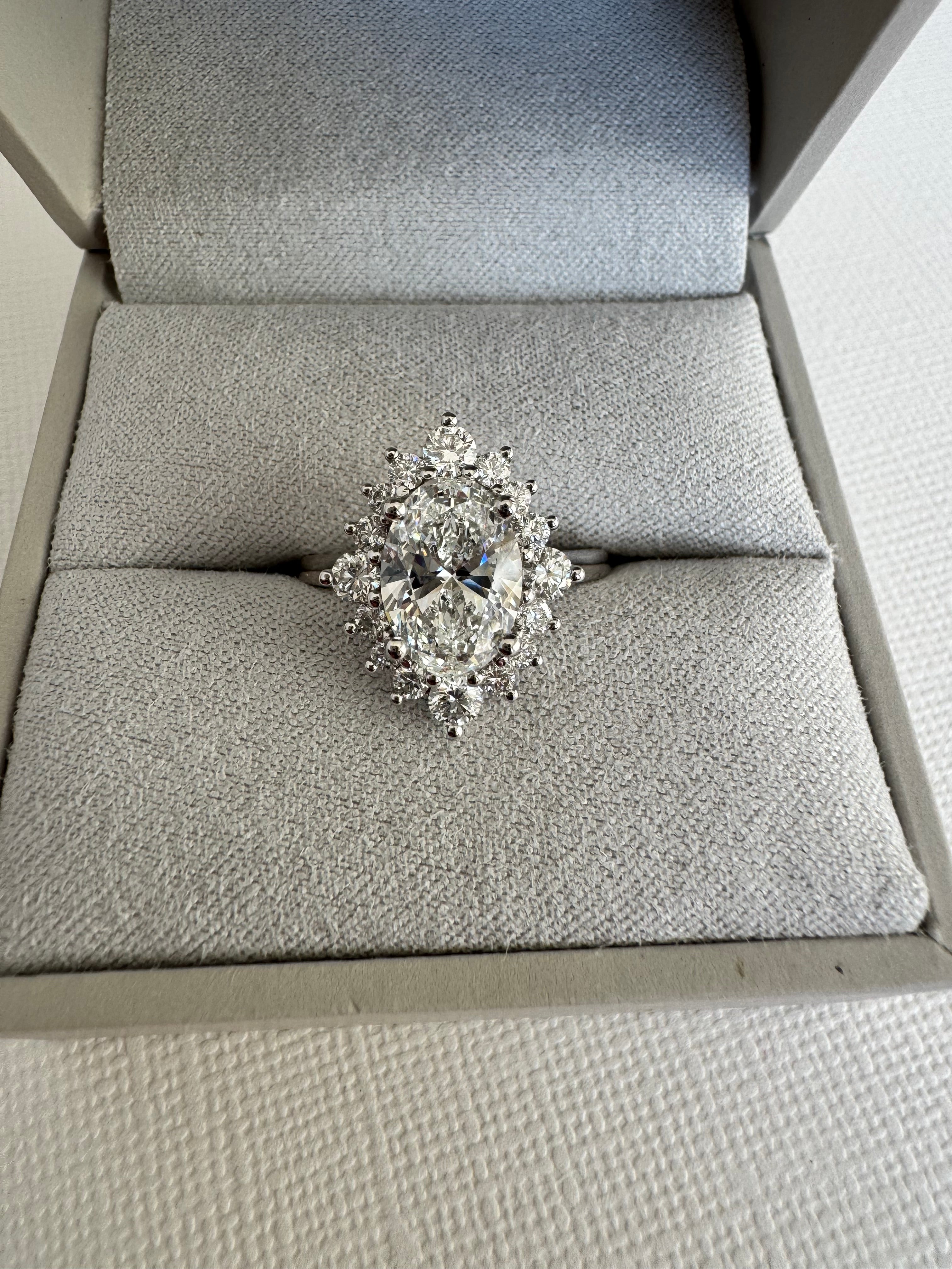 Custom 14k white gold lab grown diamond oval halo engagement ring. Size 7.25. Center= 2.01 ct lab grown oval diamond (E color, VS1 clarity). IGI certified.