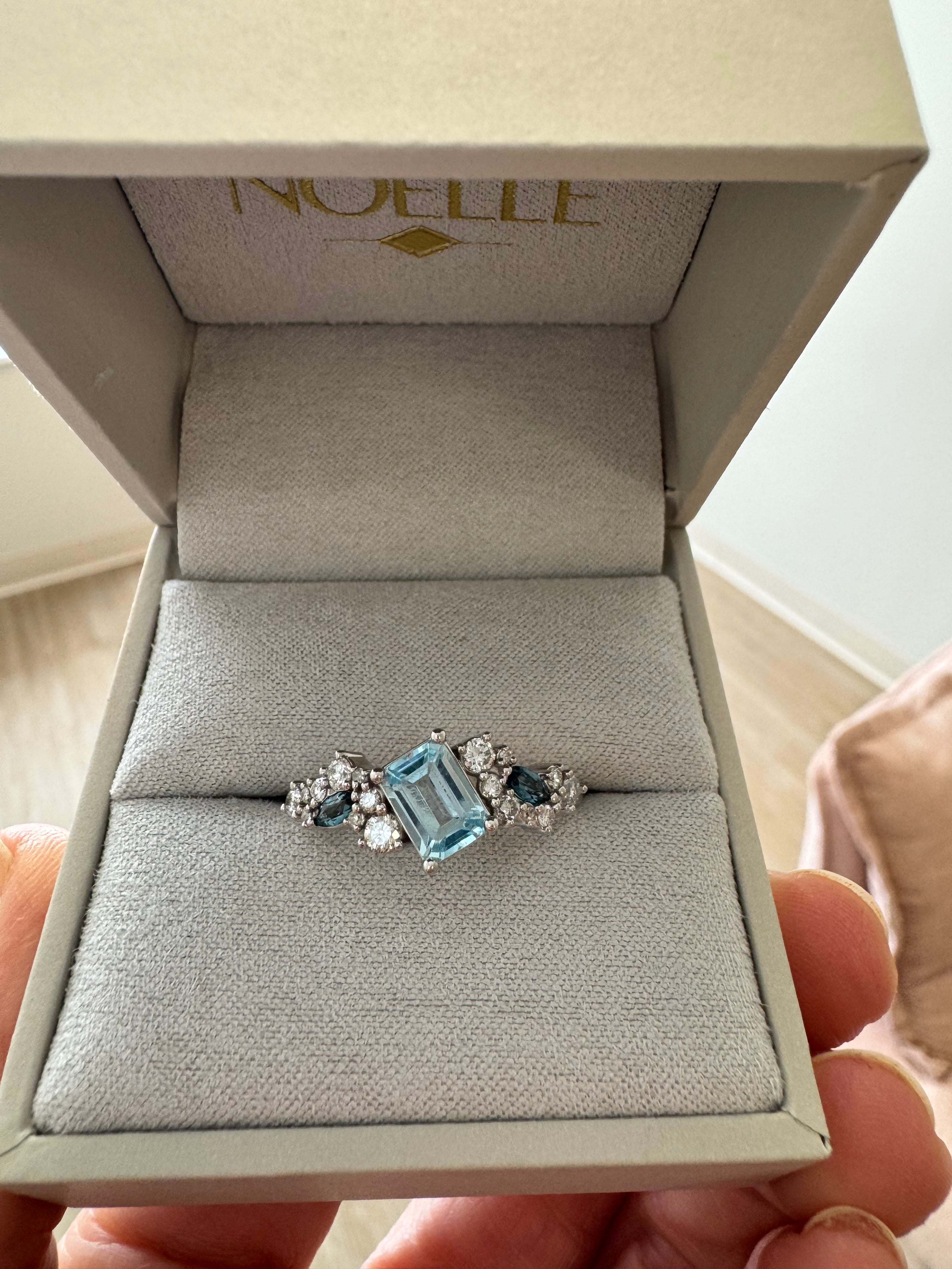 Custom, 14k white gold diamond and blue topaz cluster ring using customer's 18 round diamonds & 1, emerald cut blue topaz and supplying 2, 4x2mm marquise London blue topaz's. Size 10.5.