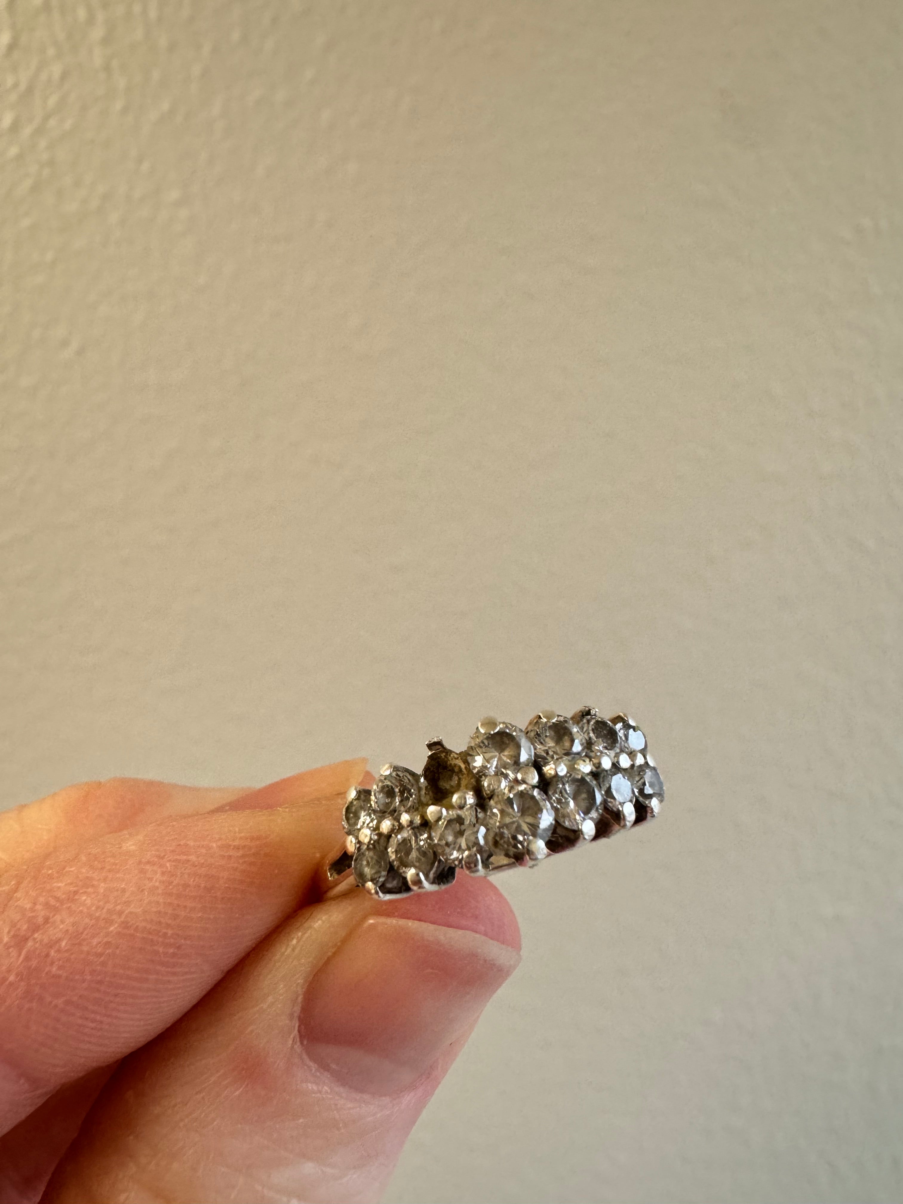 Replace missing CZ (use CZ from other ring provided by client). Retip this CZ & 1 other (3 over from missing one). Round out & polish.