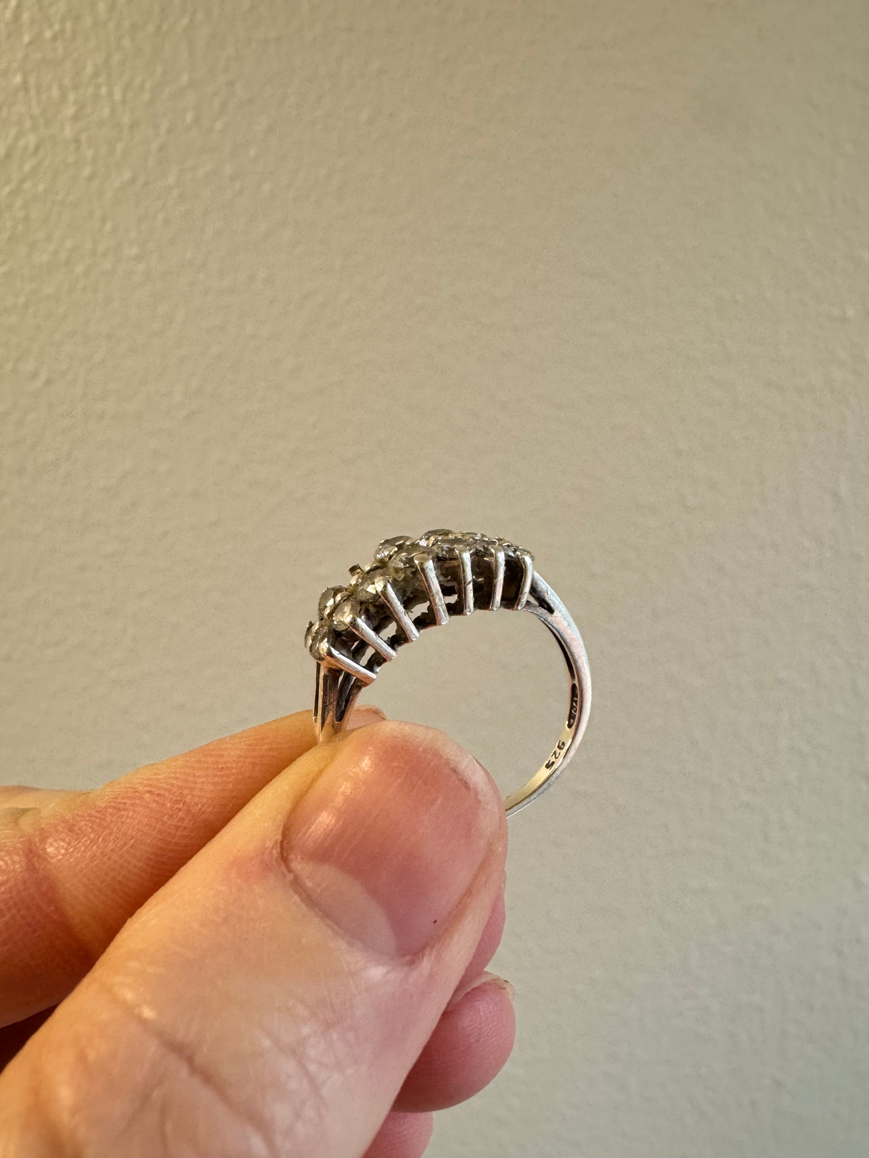 Replace missing CZ (use CZ from other ring provided by client). Retip this CZ & 1 other (3 over from missing one). Round out & polish.