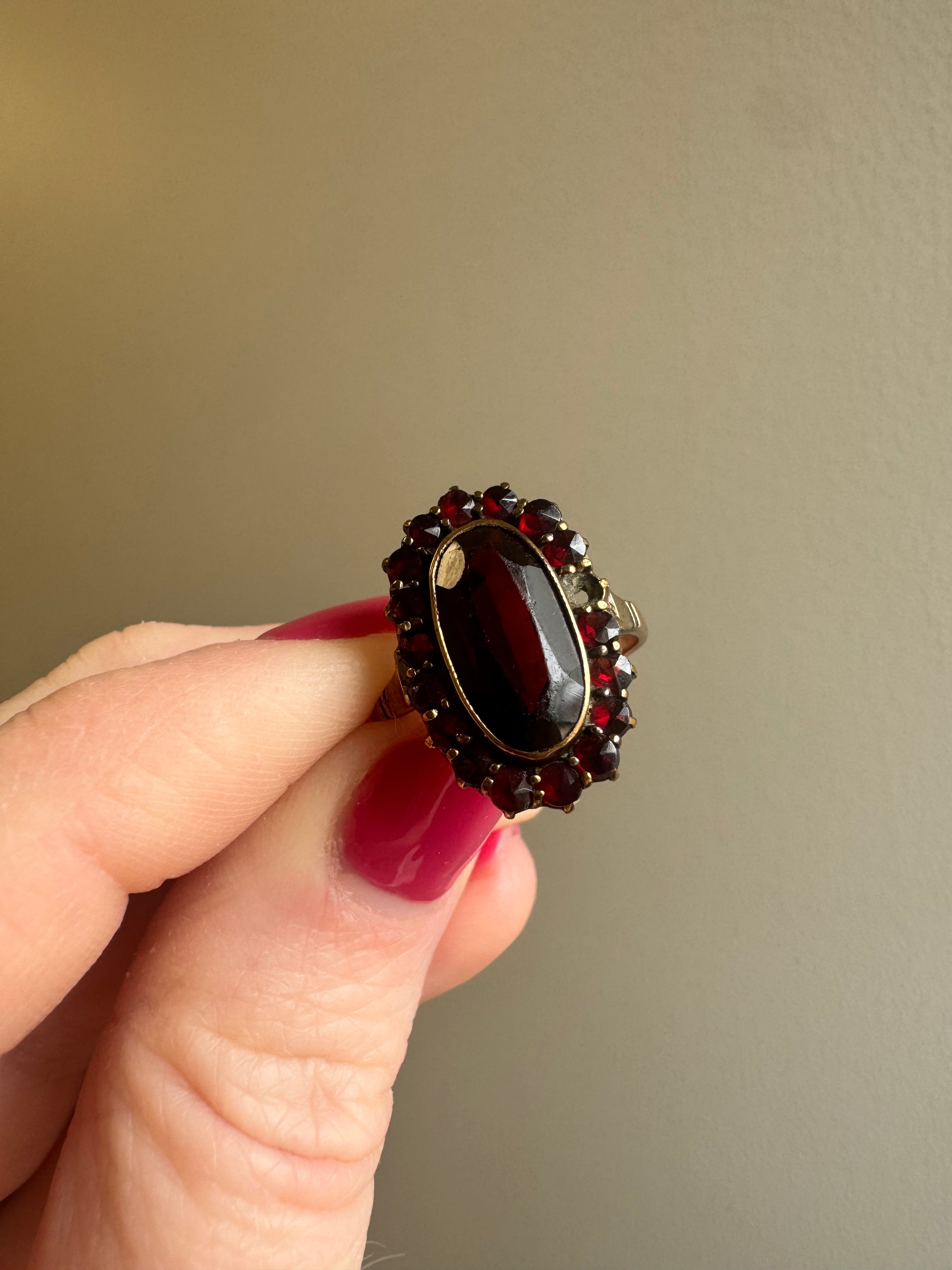 8k yellow gold garnet halo style ring: supply & set missing rose cut garnet. Retip all outside prongs. Size up to 8.5. Polish.