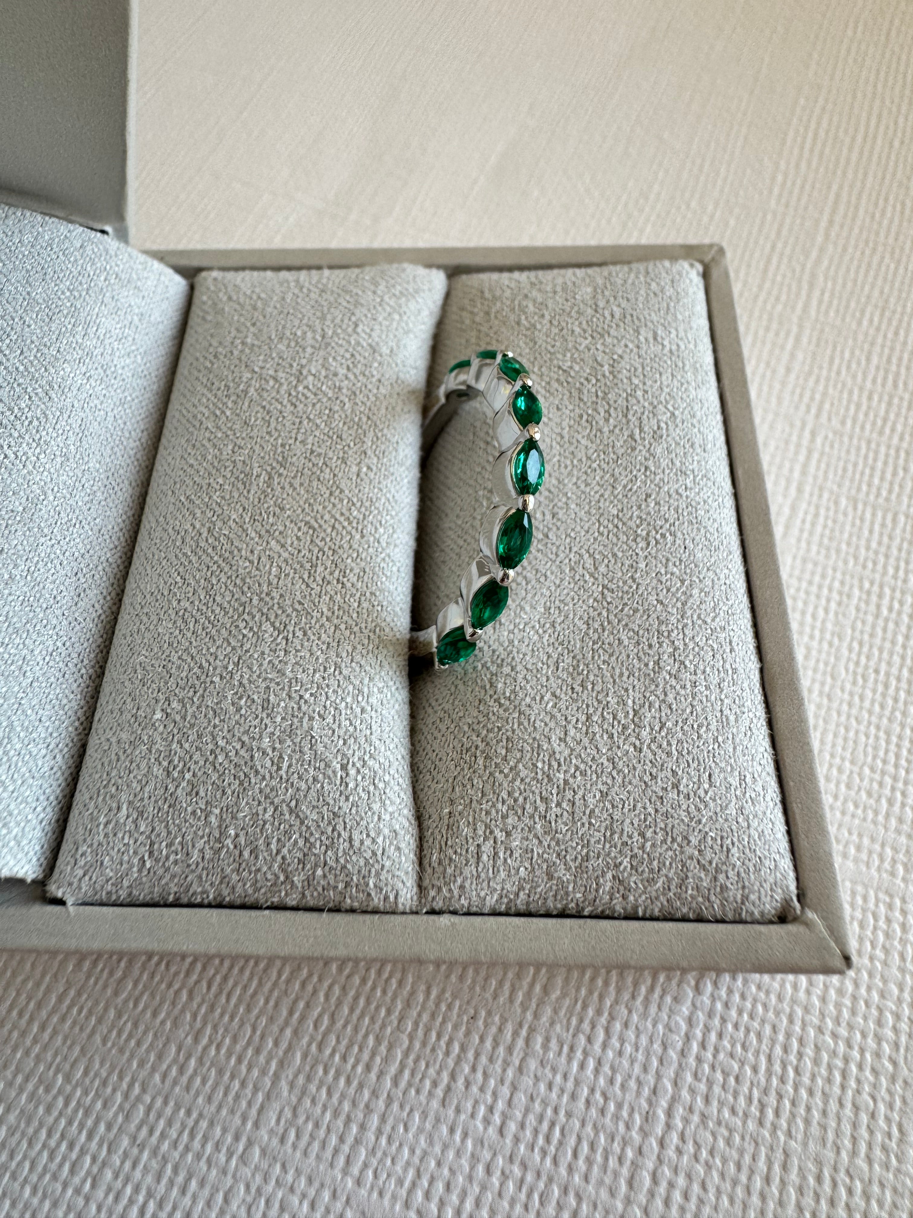 Custom, 14k white gold band with 8, lab grown marquise shaped emeralds (4x2mm) totaling approx. .48 carats. Size 7.5.