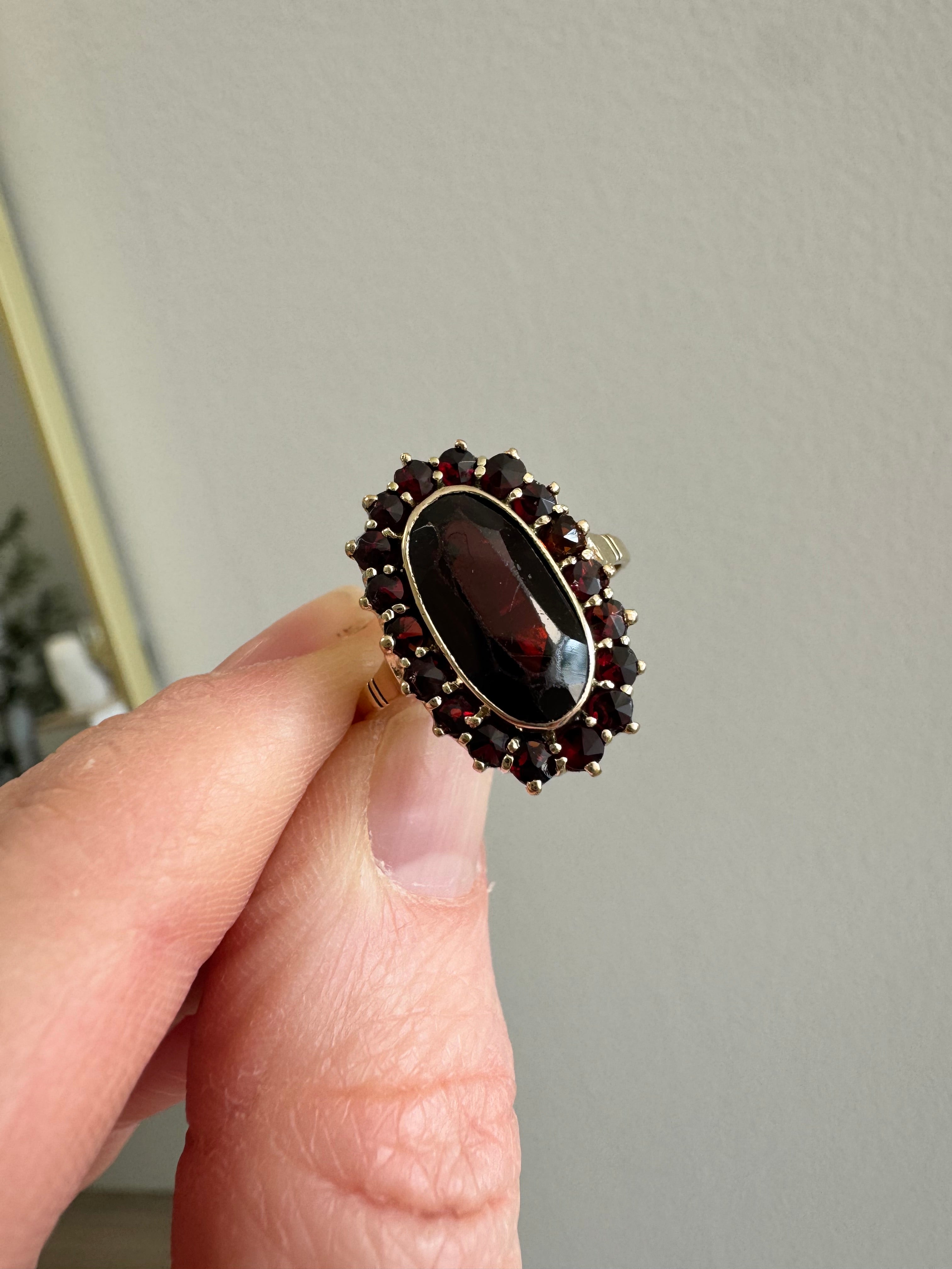 8k yellow gold garnet halo style ring: supply & set missing rose cut garnet. Retip all outside prongs. Size up to 8.5. Polish.