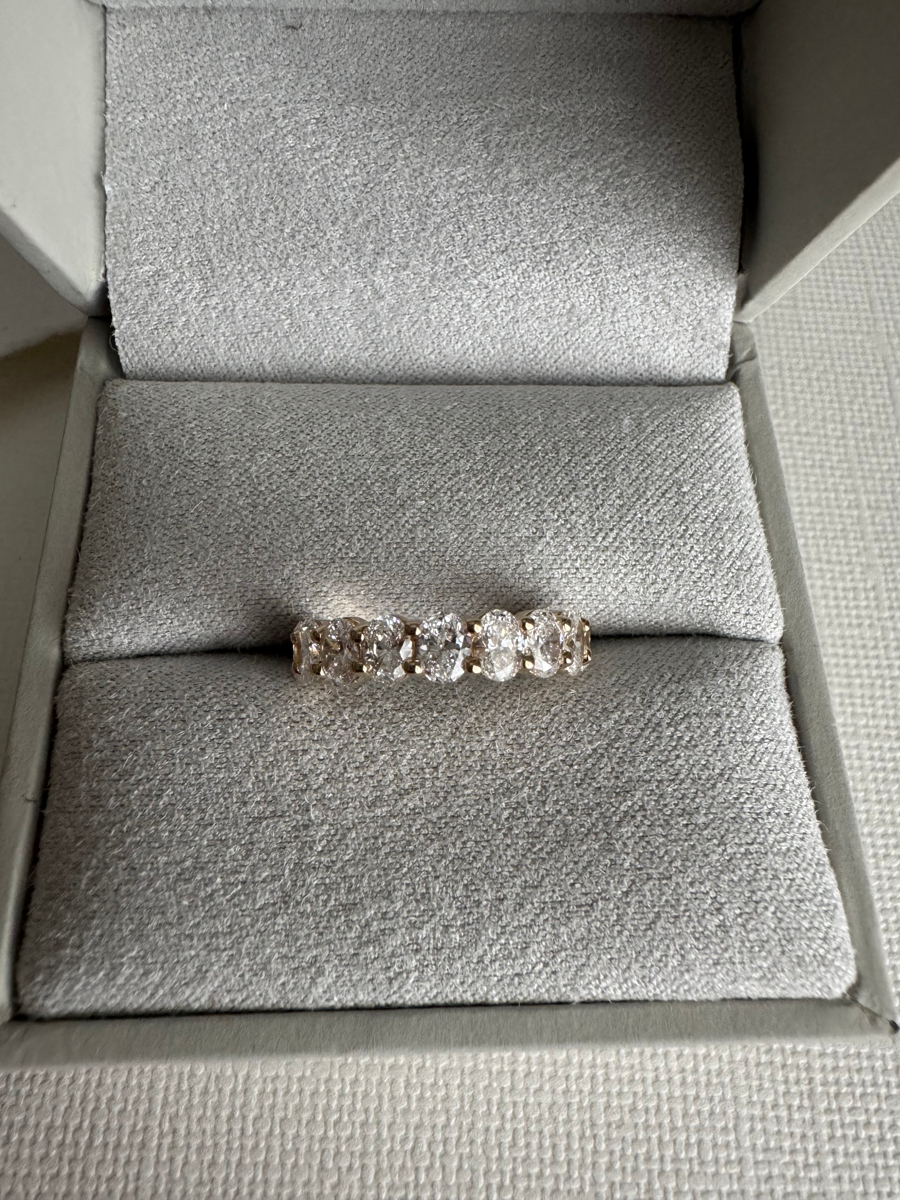 One, custom 14k yellow gold shared prong style oval lab grown diamond wedding band in a size 4. Total carat weight is 1.39 carats & the diamonds are EF color and VS1-VS2 clarity.
