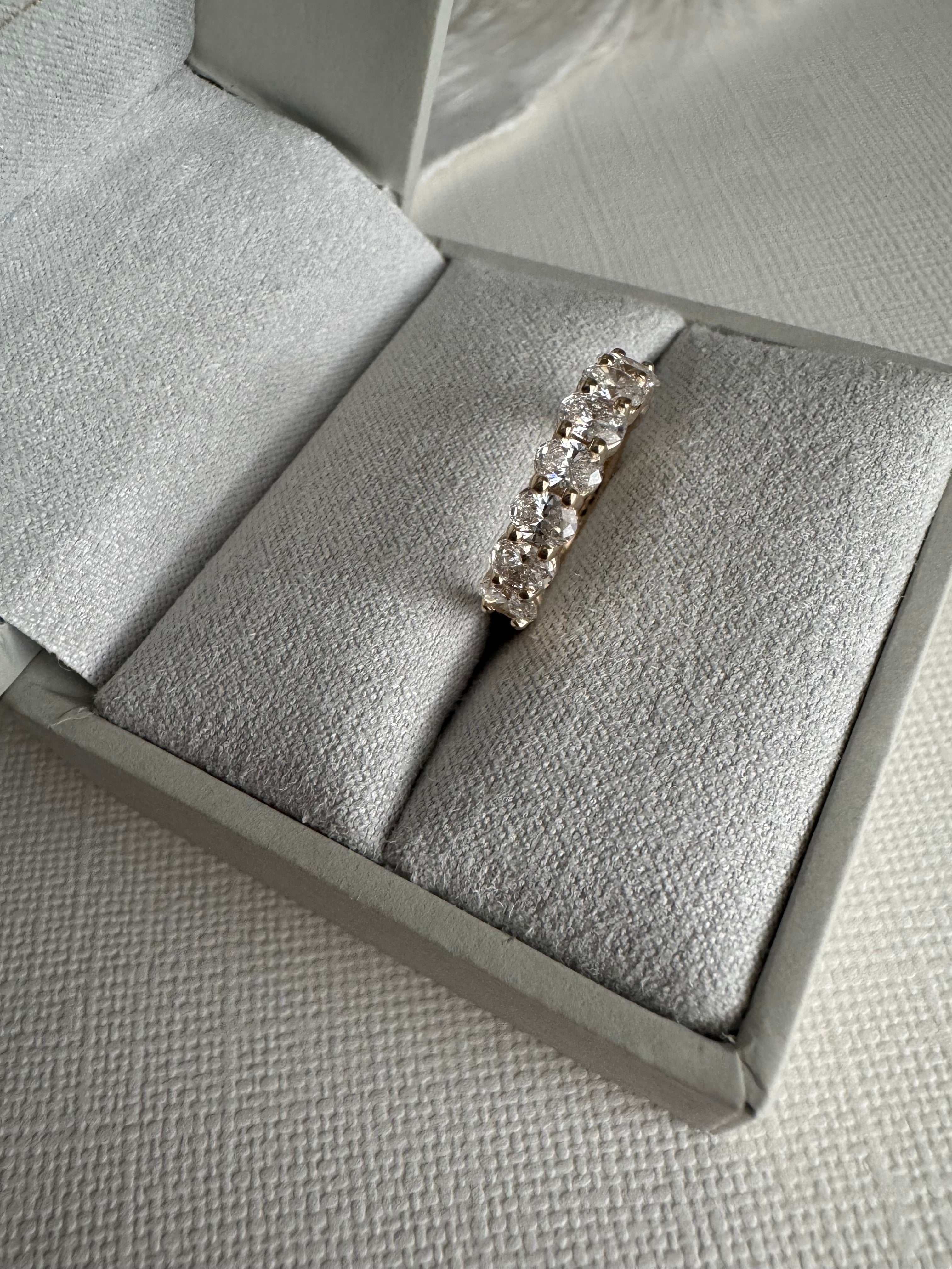One, custom 14k yellow gold shared prong style oval lab grown diamond wedding band in a size 4. Total carat weight is 1.39 carats & the diamonds are EF color and VS1-VS2 clarity.
