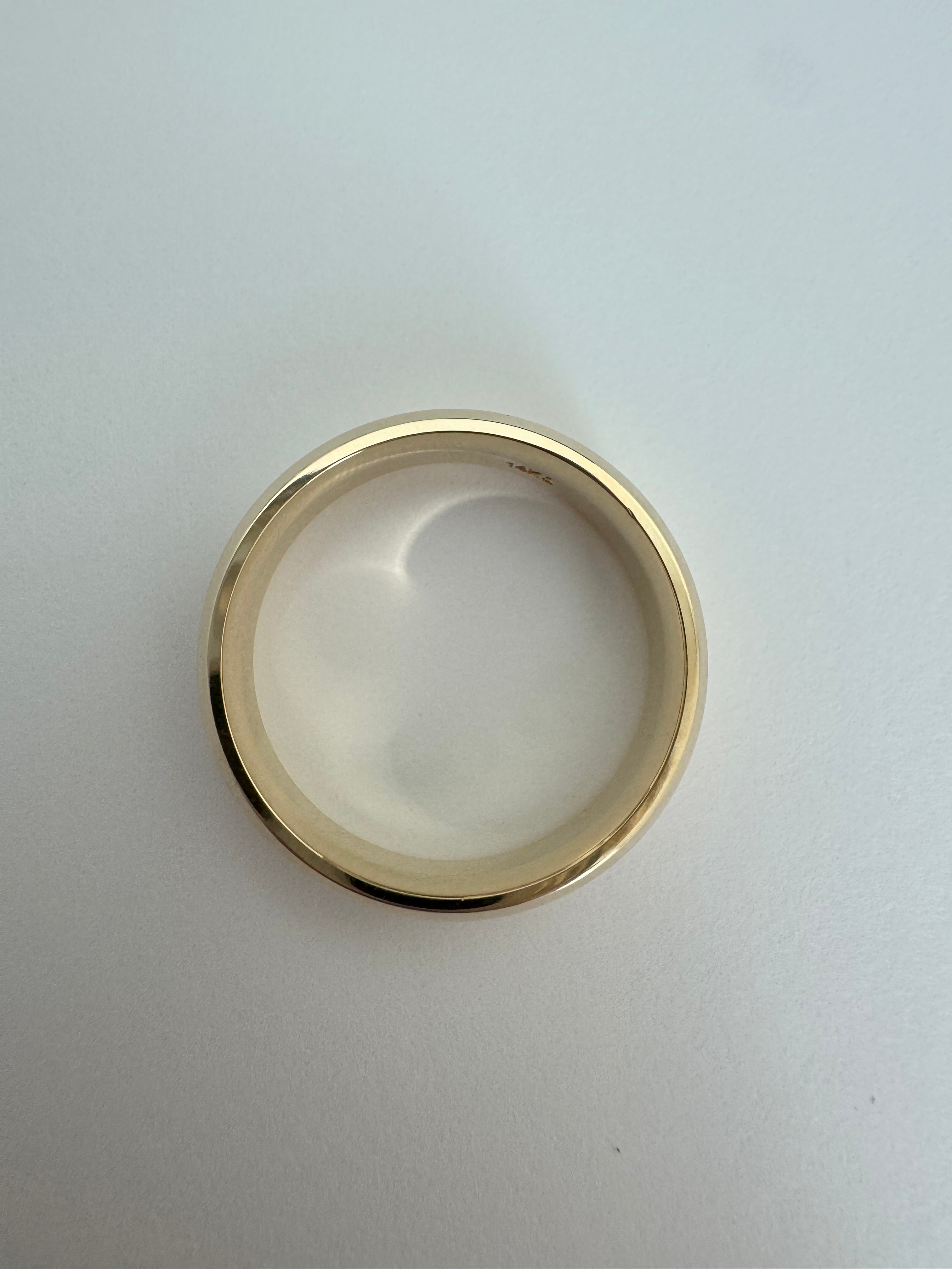 14k yellow gold, 6mm wide, comfort fit band. The ring has a half round, beveled edge detail. Size 9.  4.679 dwt.
