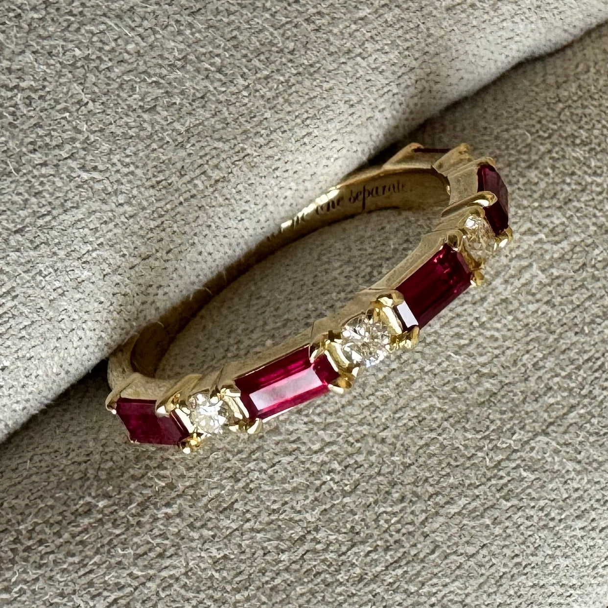 Custom 14k yellow gold, engraved,wedding band with 5, 4x2mm straight baguette natural AA quality rubies and 4, 2mm round brilliant cut natural diamonds. Size 5.5. (Rubies= approx. 0.85cts. Dias= approx. 0.12 cts)