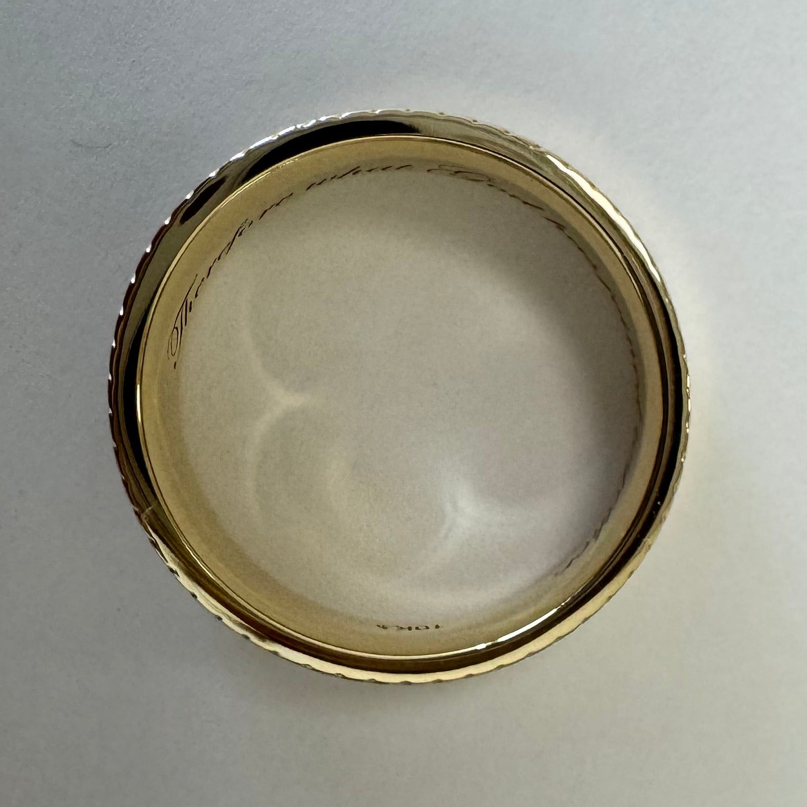 10K Yellow Gold 7 mm Milgrain & Rope Stepped-Edge Comfort-Fit Flat Band. Size 7.5. The ring is engraved in Edwardian Script with "Therefore what God has joined together,"