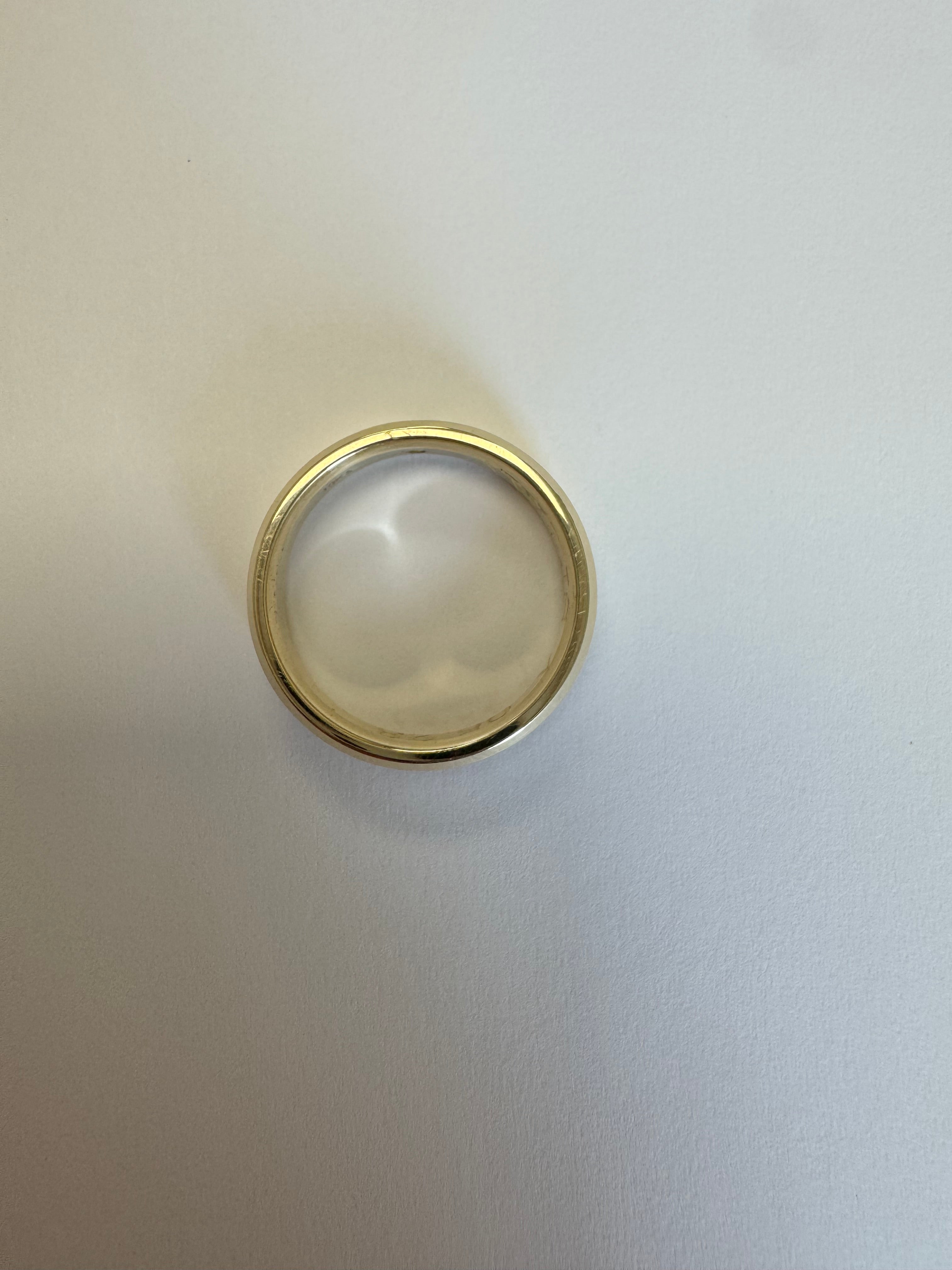 10k yellow gold 5mm wide, beveled edge half round wedding band with a 2mm genuine peridot (AA quality) flush set. Engraved on the inside in Bookman font: "AW+JS   05.23" There is a special character between the JS and the 05 (upside down V) Size 8.
