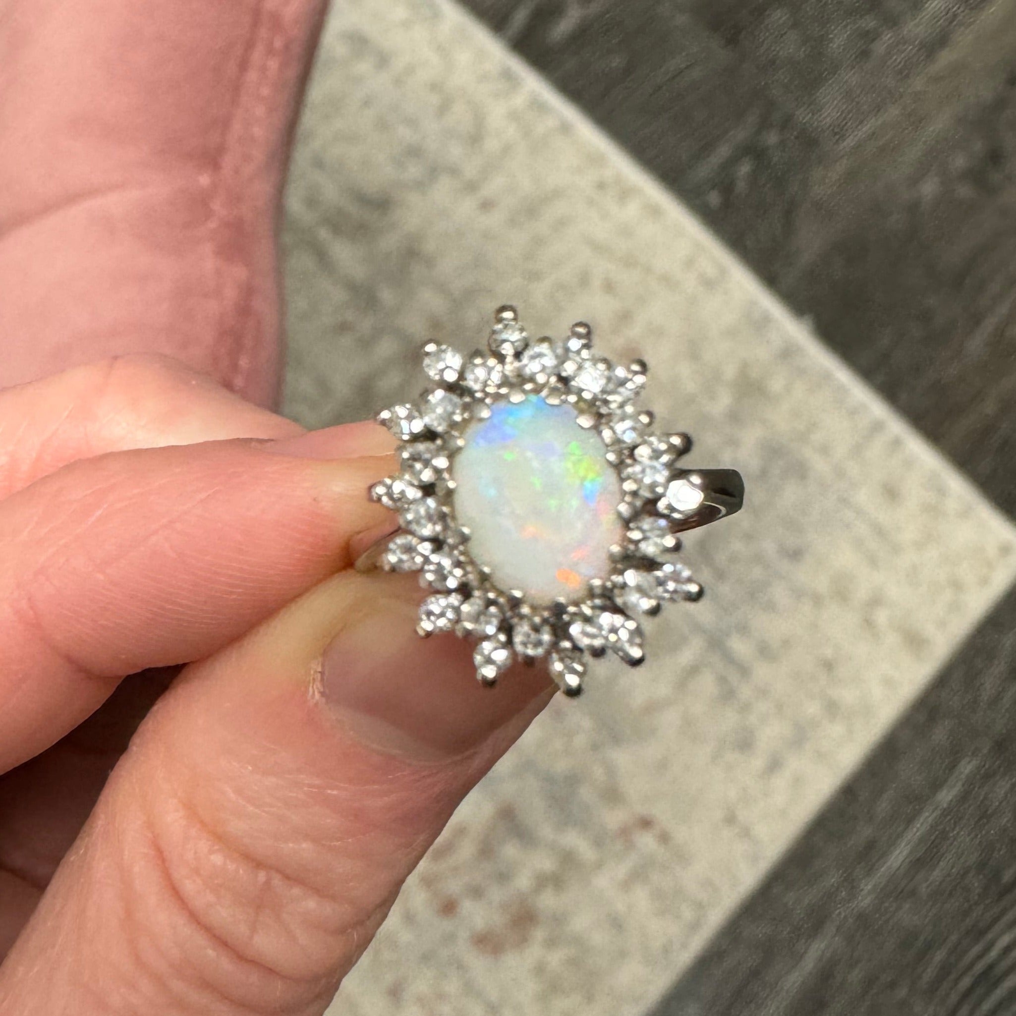 Sizing: 14k white gold starburst style diamond halo oval opal ring