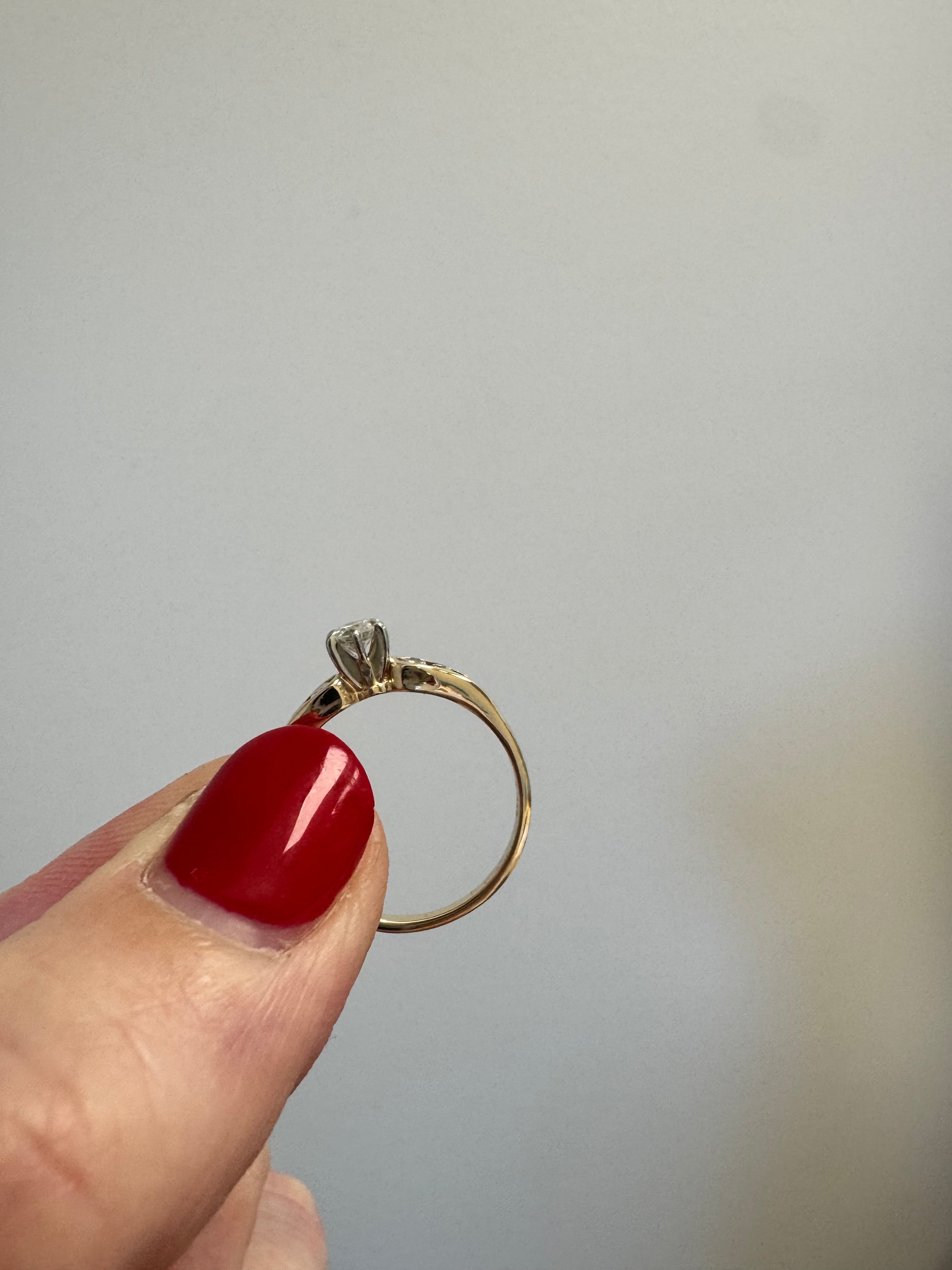 Ladies yellow gold engagement ring with 1 center and 4 melee diamonds. Size up to 5.5 from 5.