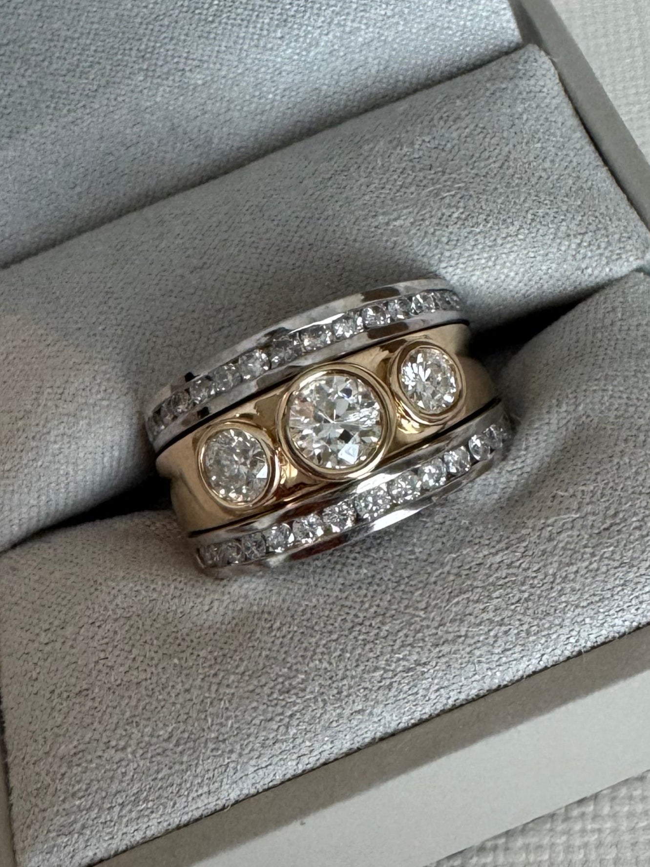 Custom 14k yellow and white gold 3 piece wedding set. All customer's diamonds. 3 stone bezel set ring with 2 channel rings. Eng Ring= 1.08 cttw. Bands= .83 cttw. Size9.