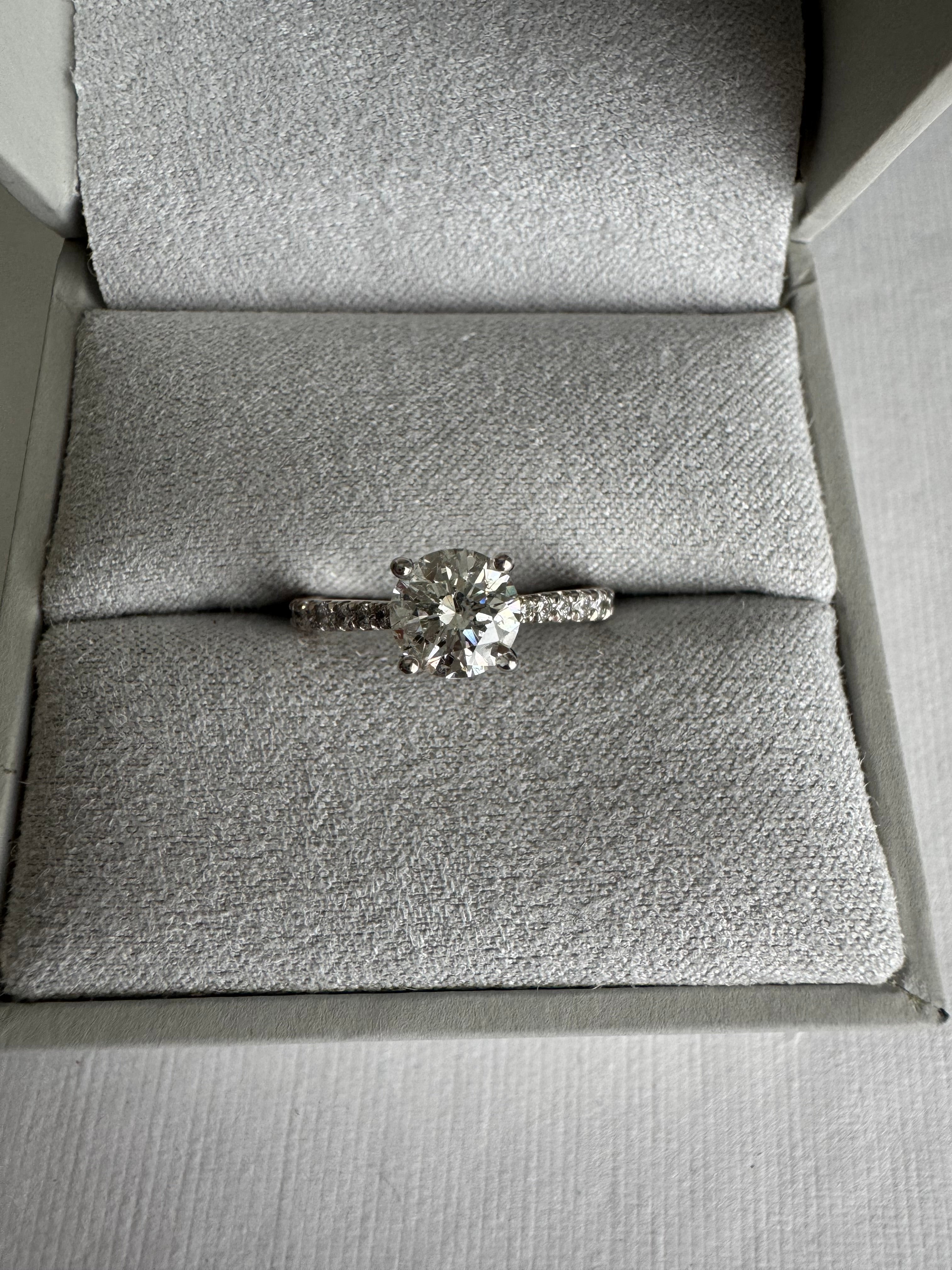 14k white gold lab grown diamond engagement ring set with customer's 6mm round diamond. The mounting contains 16 round lab grown diamonds totaling approx. .21 cts. Size 5.75