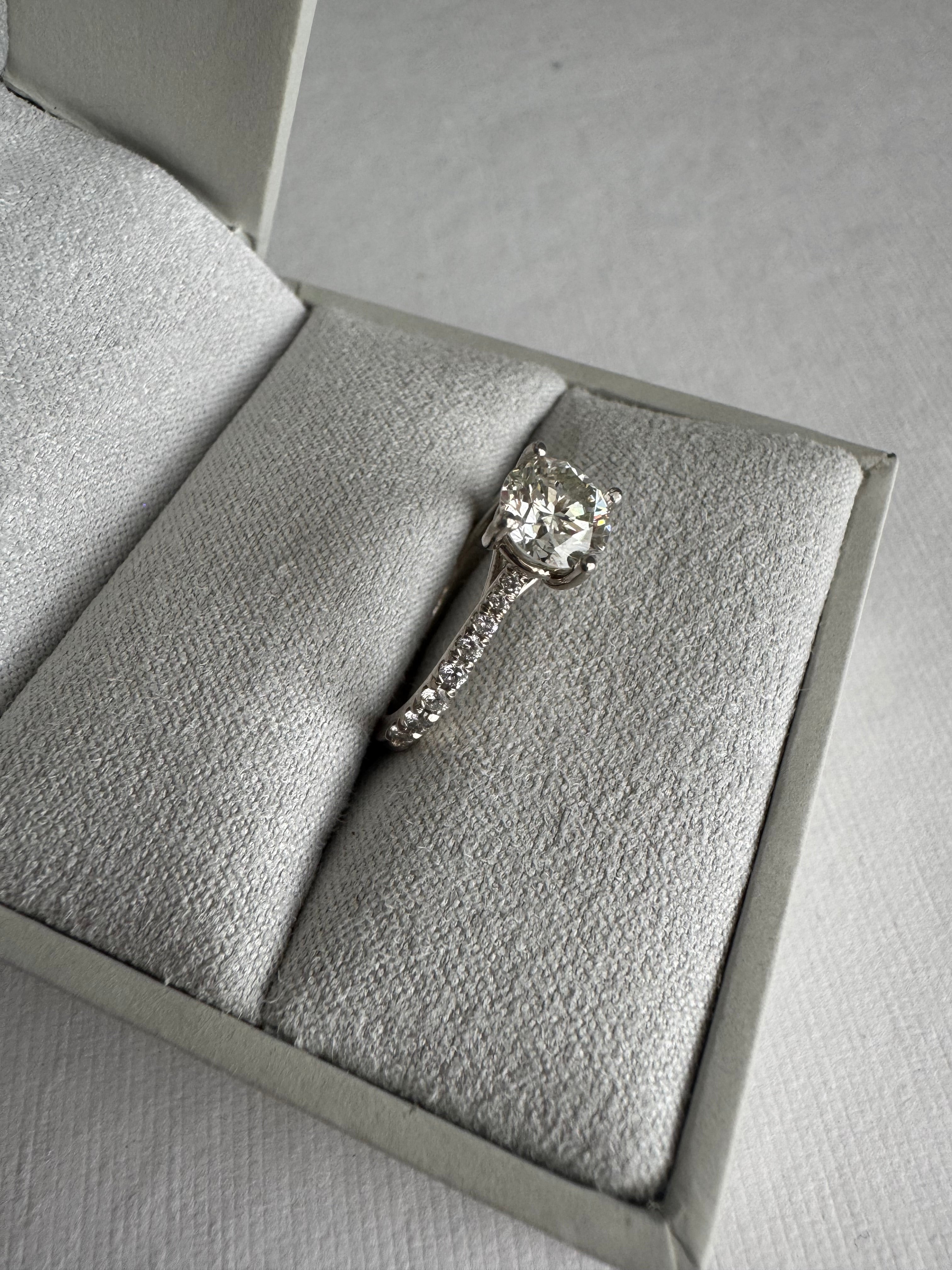 14k white gold lab grown diamond engagement ring set with customer's 6mm round diamond. The mounting contains 16 round lab grown diamonds totaling approx. .21 cts. Size 5.75