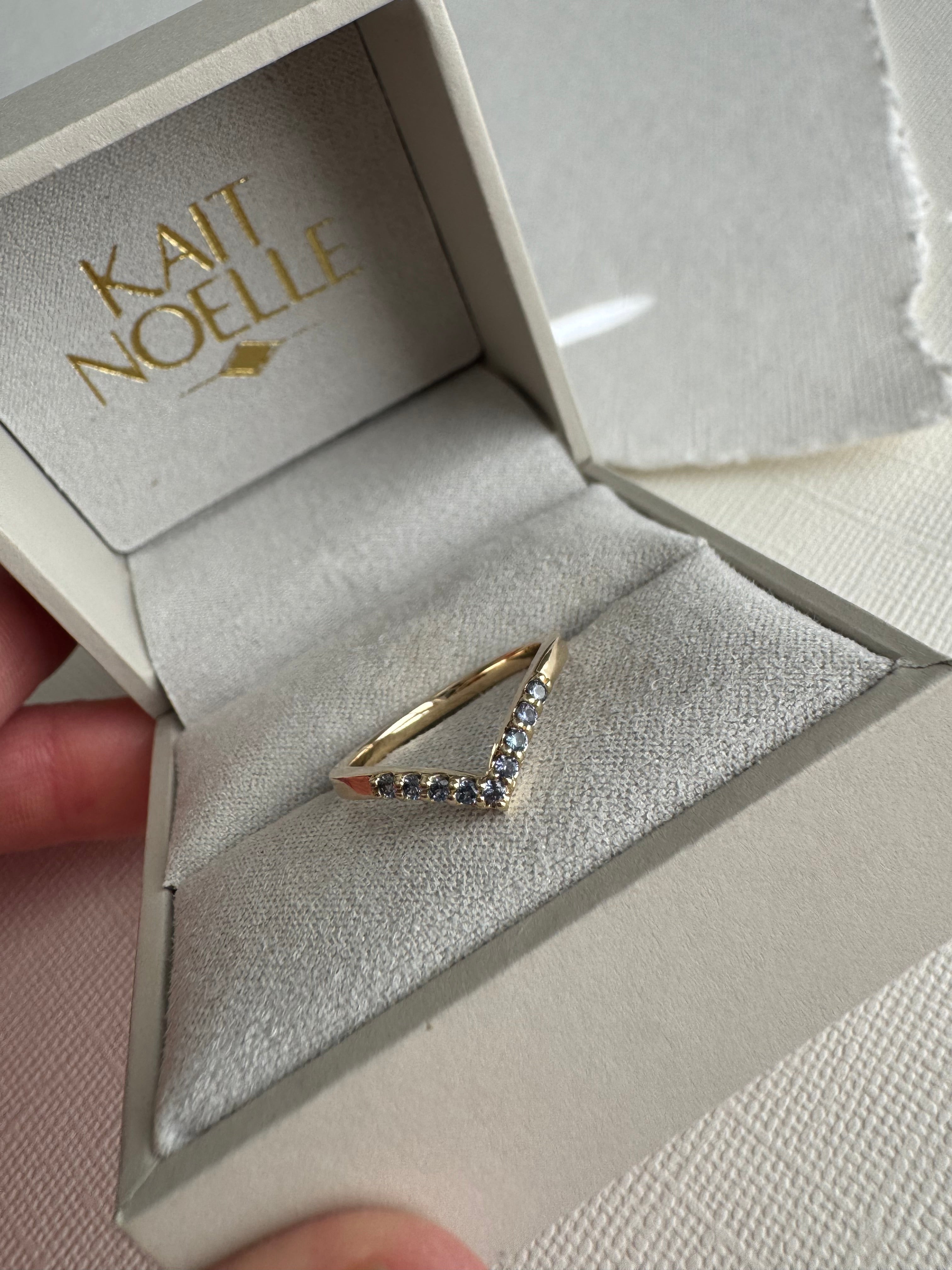 Custom 10k yellow gold Yogo Montana sapphire contoured wedding band. (10 sapphires total 0.13 carats) Size 5.