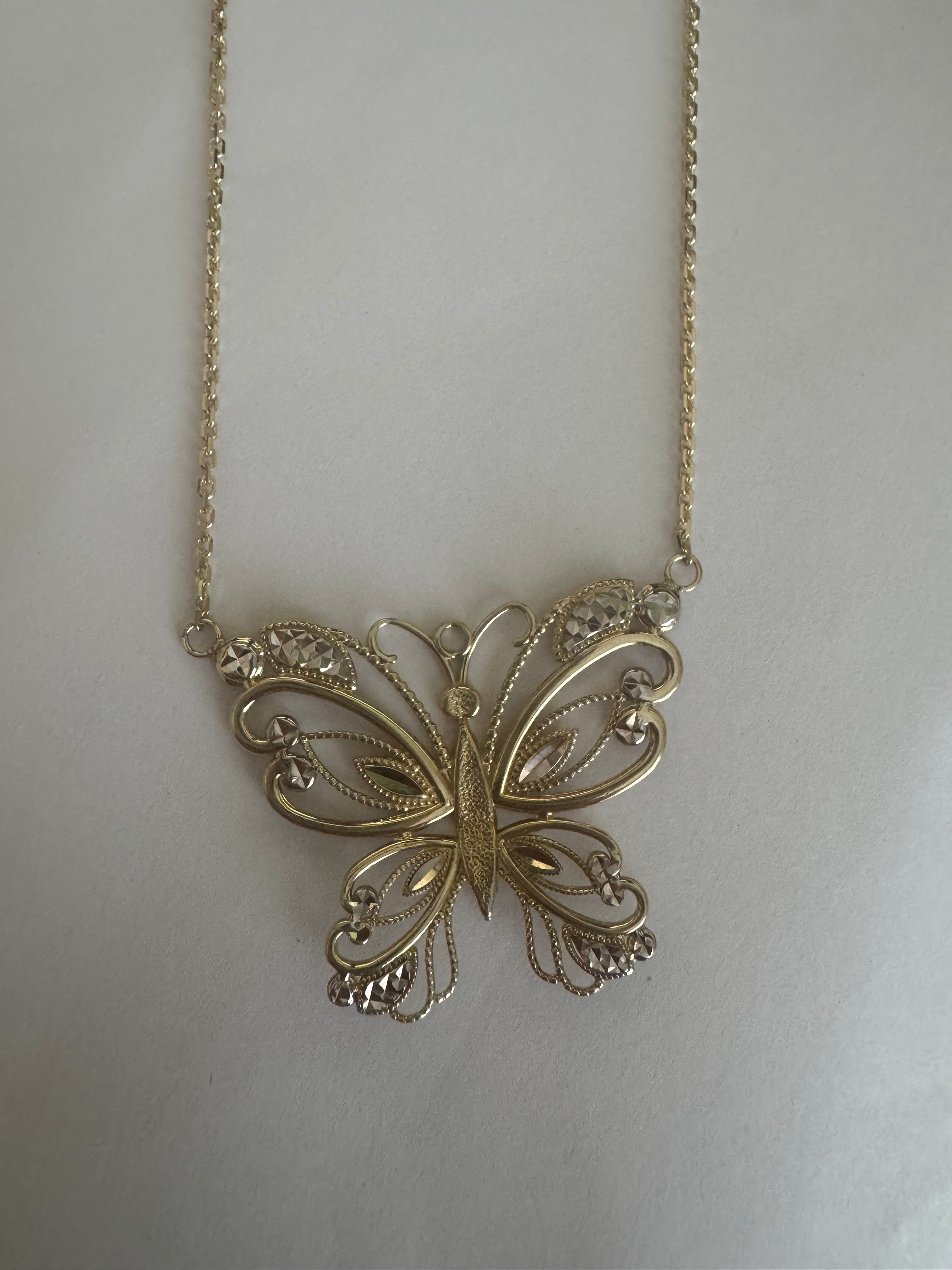 Supply 10k y/g, 1.3mm wide, diamond cut cable chain. Remove bail from butterfly pendant and station in chain. Make 12.5" overall.