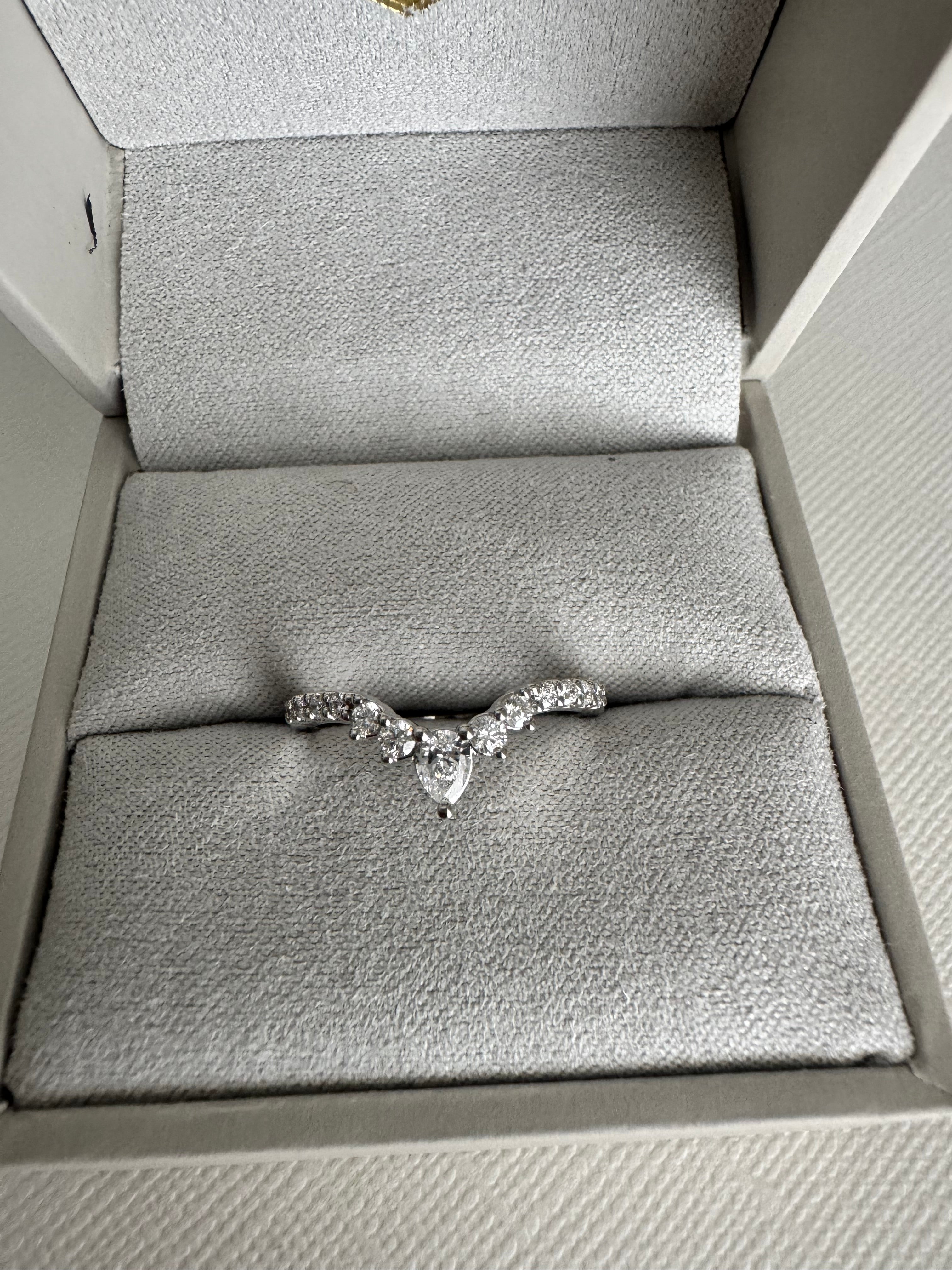 Custom 14k white gold curved lab grown diamond band with a pear shaped center. Size 6.5. Carat weight approx. 0.37 cts.