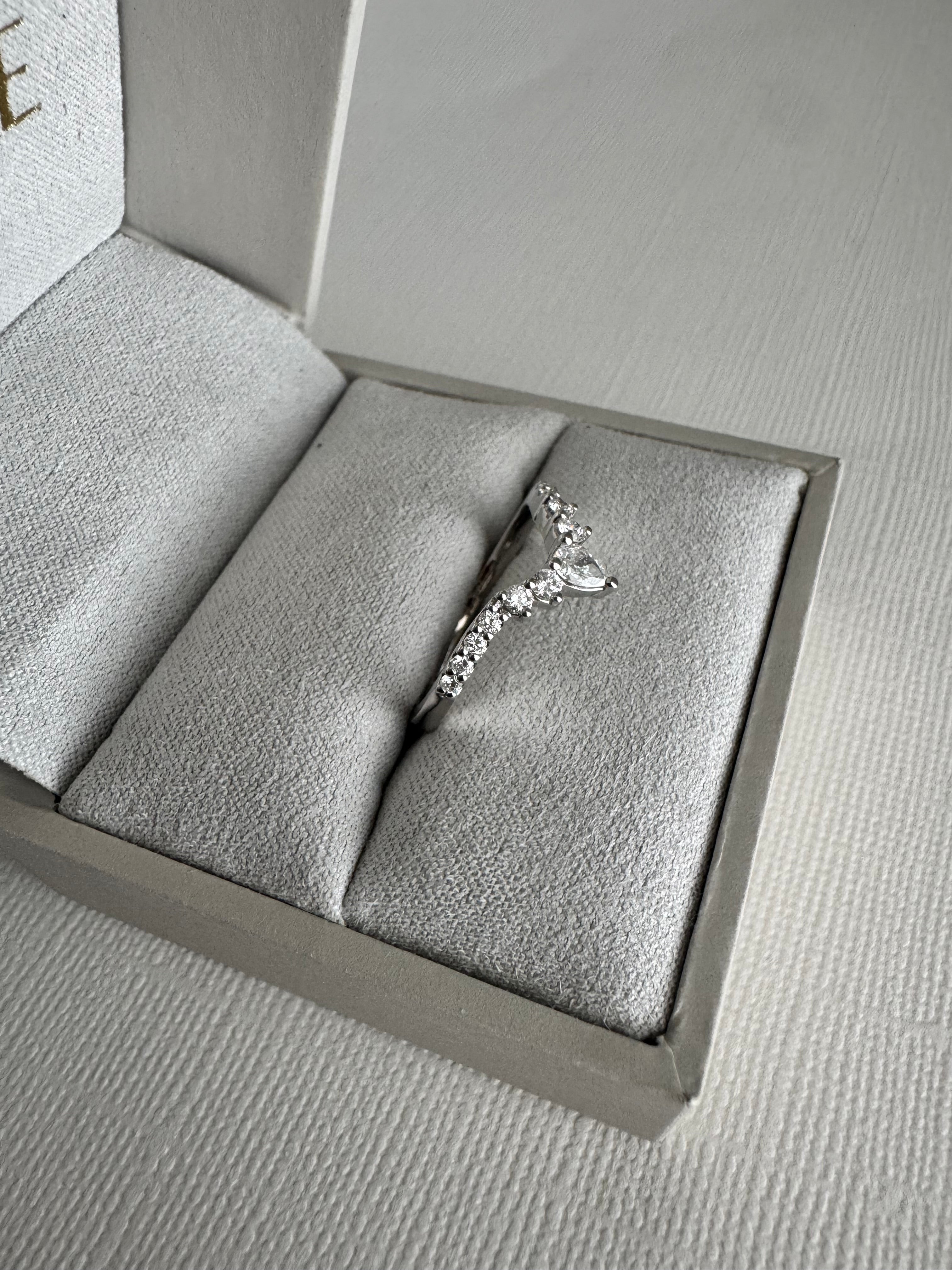Custom 14k white gold curved lab grown diamond band with a pear shaped center. Size 6.5. Carat weight approx. 0.37 cts.
