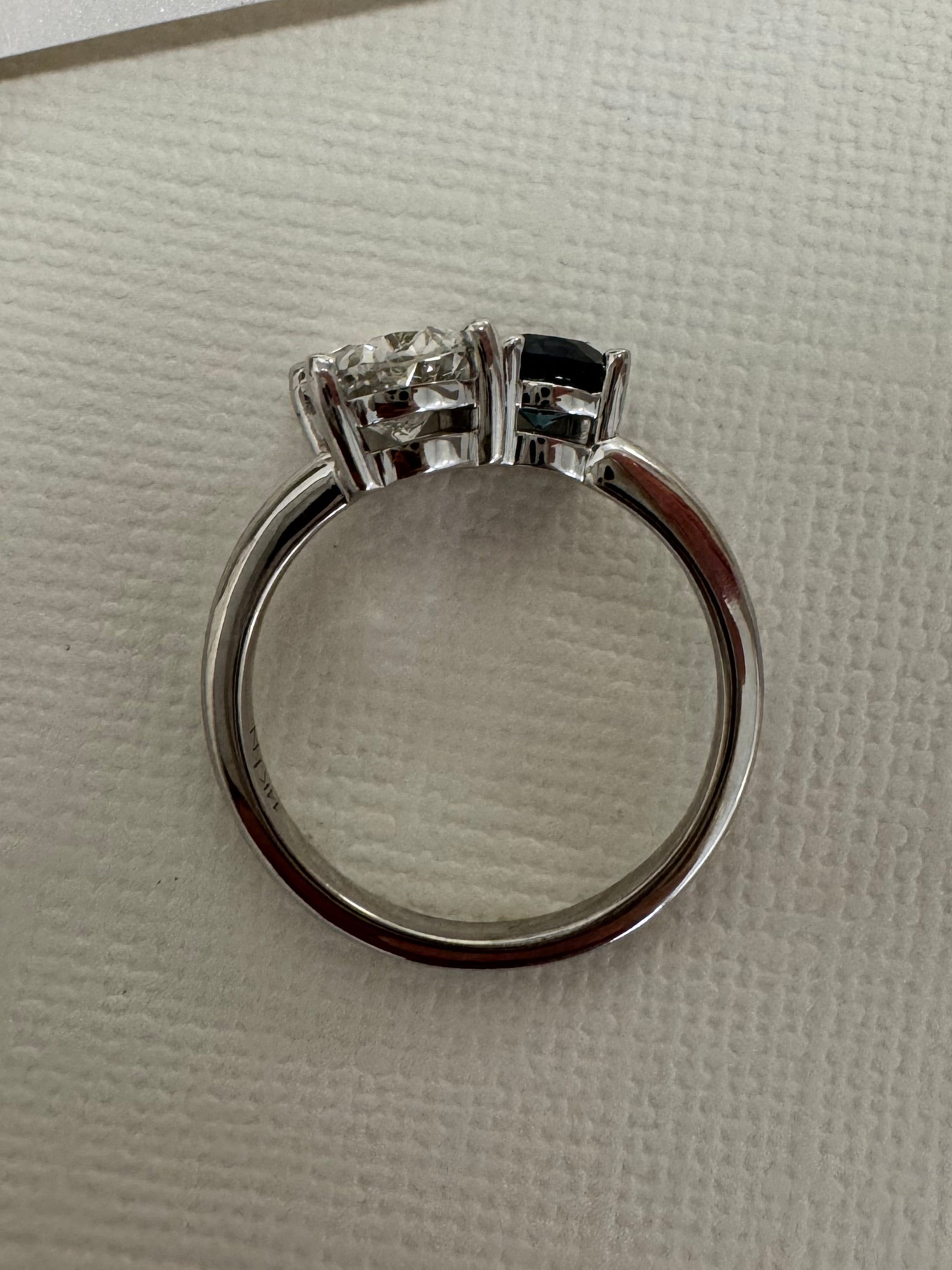 Custom 14k white gold 2 stone ring using customer's 2ct. oval lab grown diamond & supplying 1, 5.5mm round AA quality London Blue Topaz. Size 9.