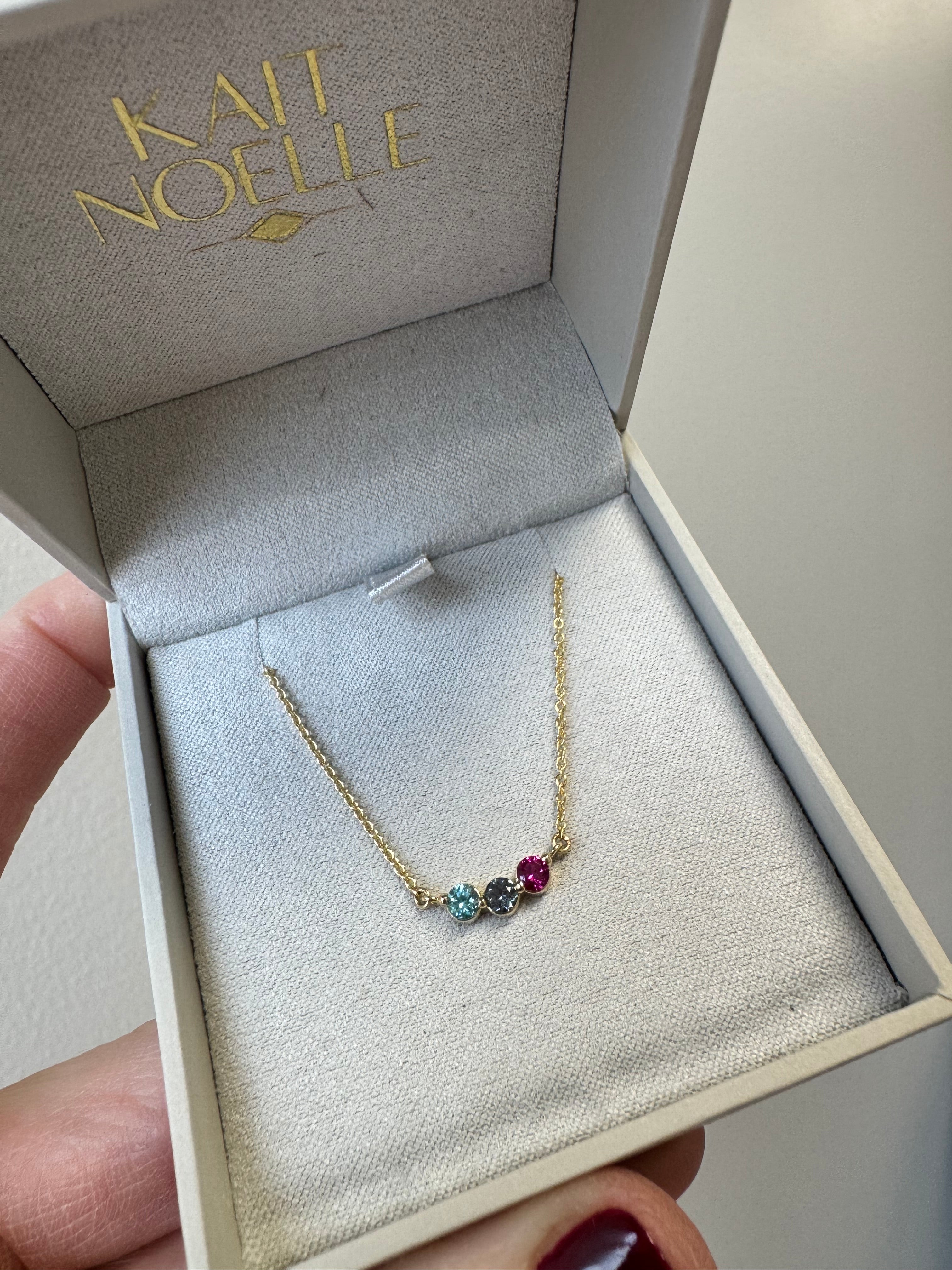 10k yellow gold Mother's necklace with 1, 3mm lab grown Alexandrite, 1, 3mm lab grown ruby & 1 3mm natural blue zircon (AA). On a 1.2mm 10k yg cable chain. 18"