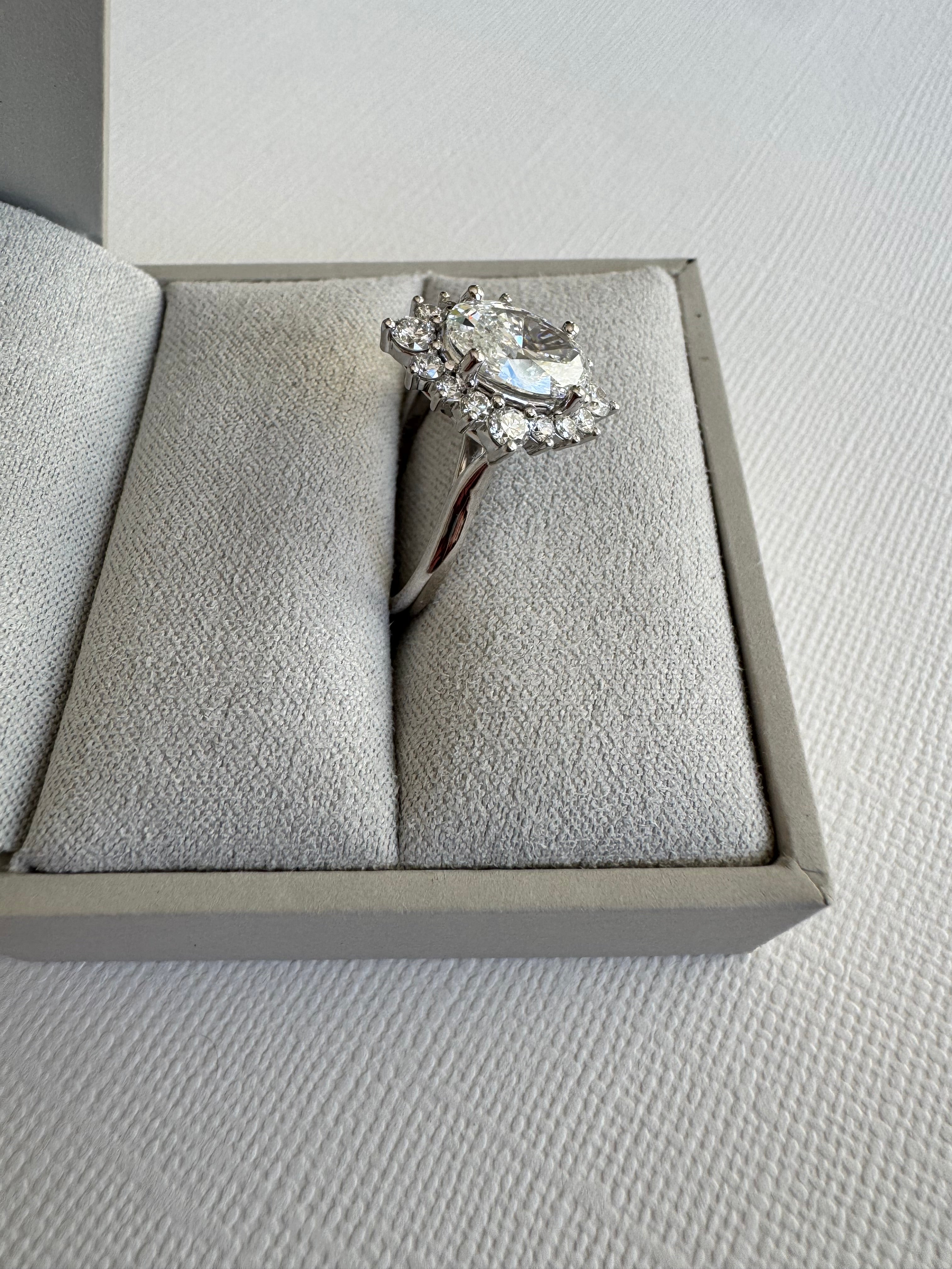Custom 14k white gold lab grown diamond oval halo engagement ring. Size 7.25. Center= 2.01 ct lab grown oval diamond (E color, VS1 clarity). IGI certified.